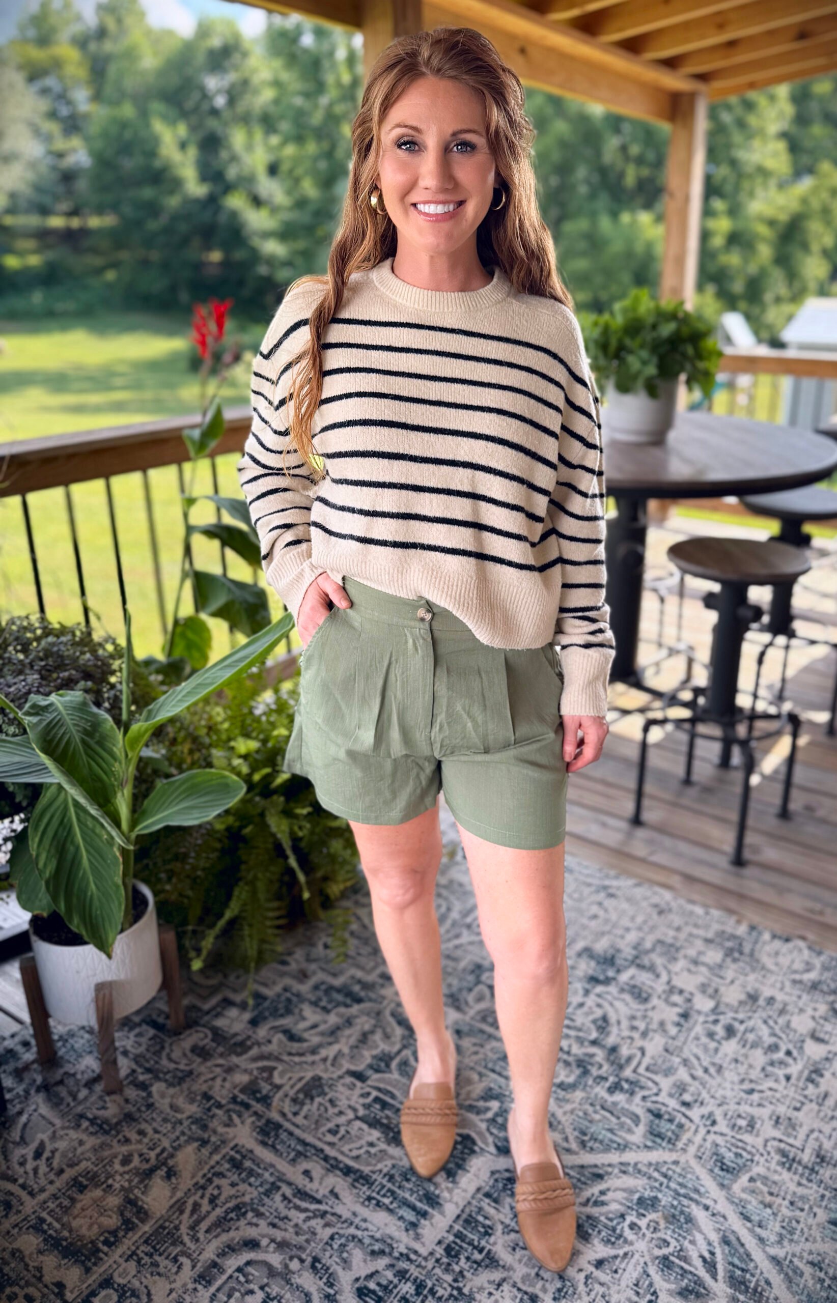 Stephanie, a petite 5'3" tall, wearing  olive green shorts from Amazon with a striped sweater