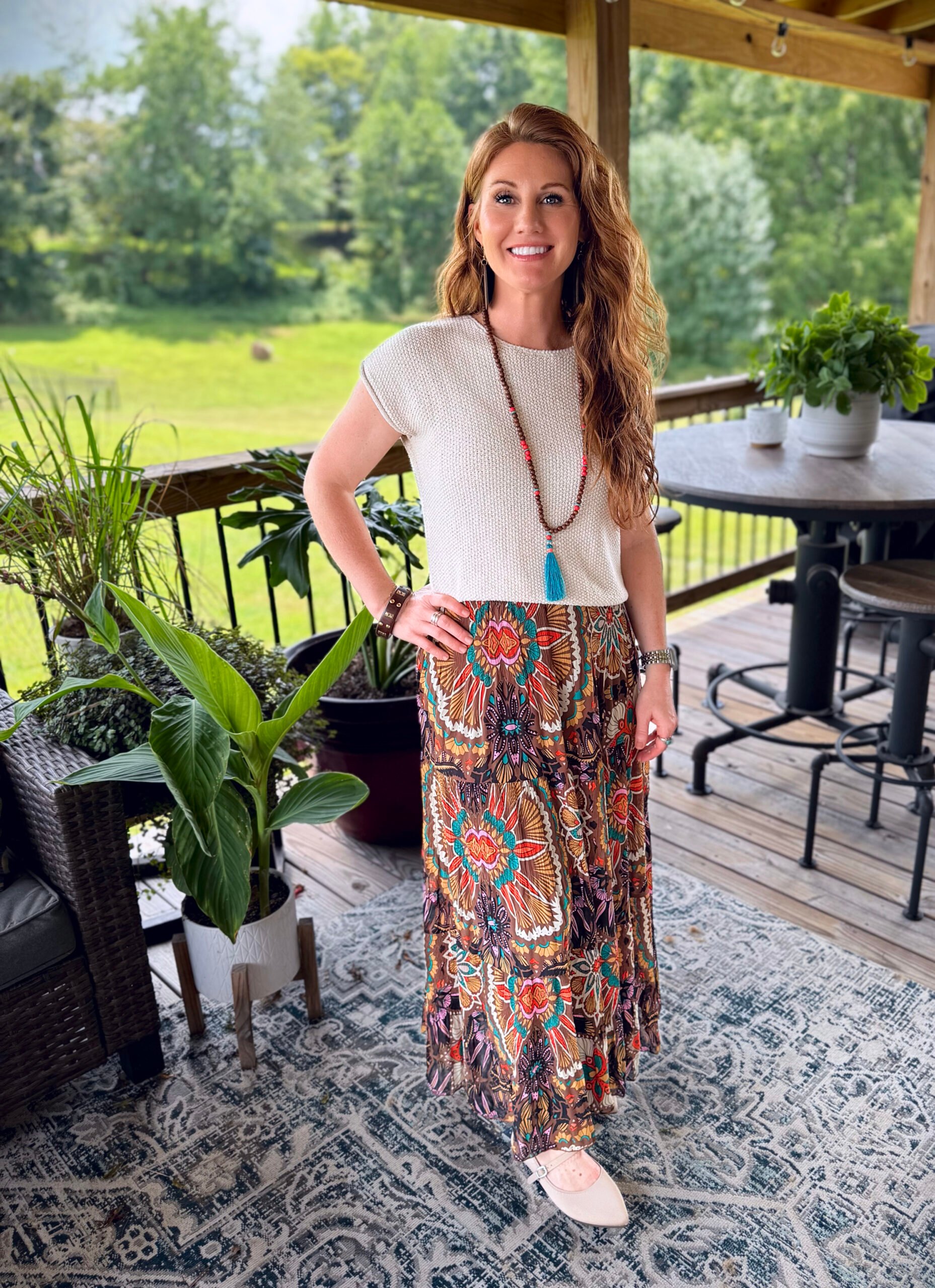 Stephanie, a petite 5'3" tall, wearing a colorful boho skirt with a cream sweater from Amazon with a white tee 