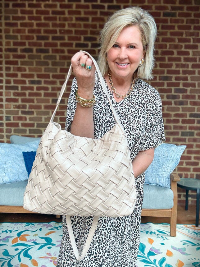 Tania holding a woven slouchy hobo style handbag