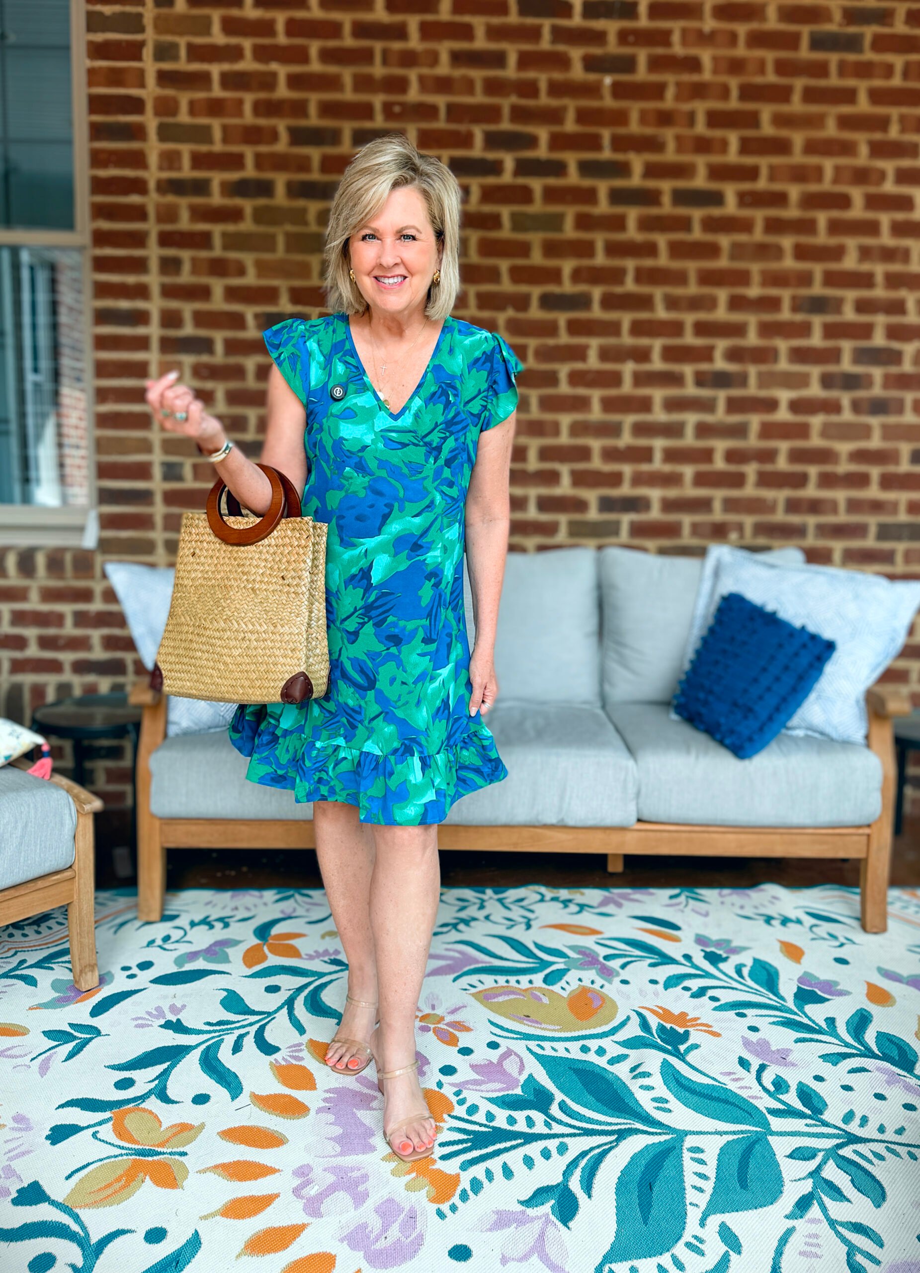 Tania wearing a blue and green sjort dress from Amazon with a straw handbag