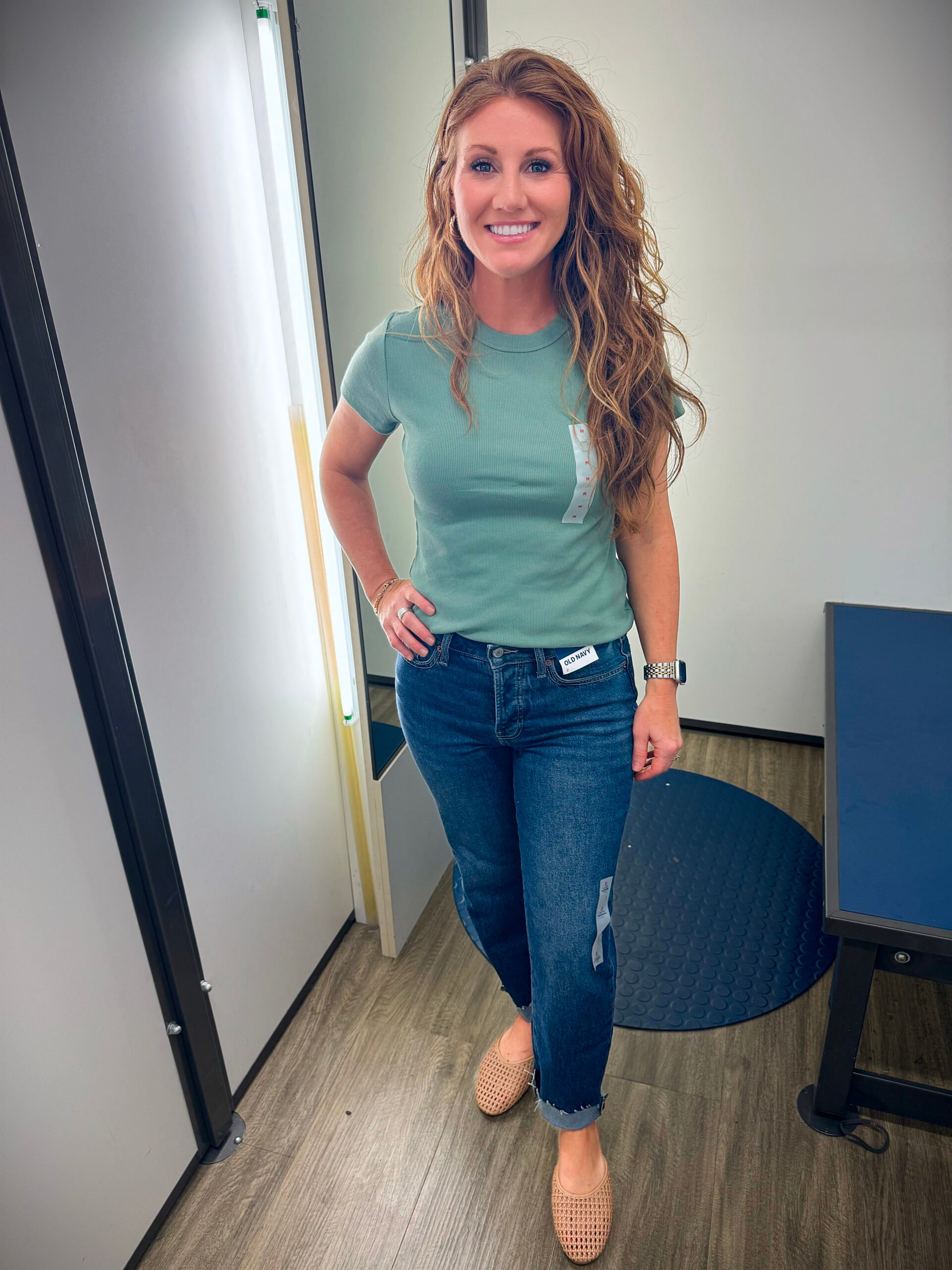 Stephanie wearing a sage green crop top and ankle jeans for petites from Old Navy