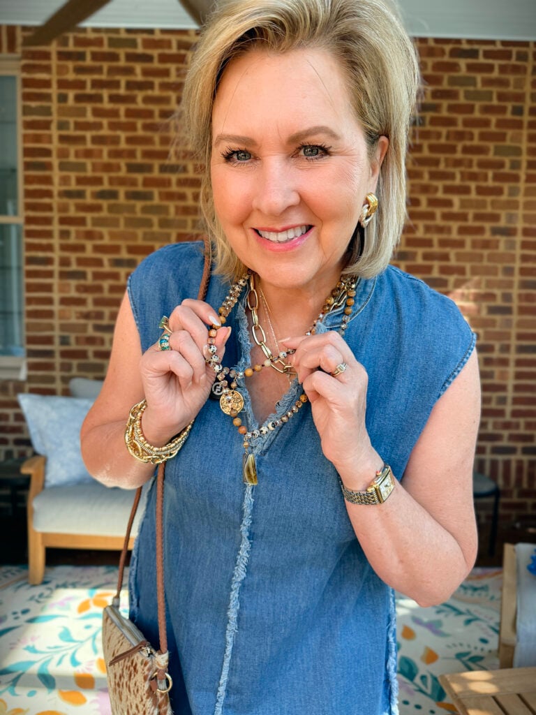 Tania is wearing a jewelry with a frayed denim dress