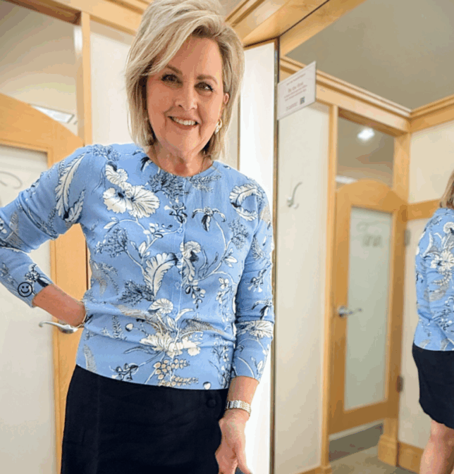 Tania wearing a blue cardigan with a navy skirt