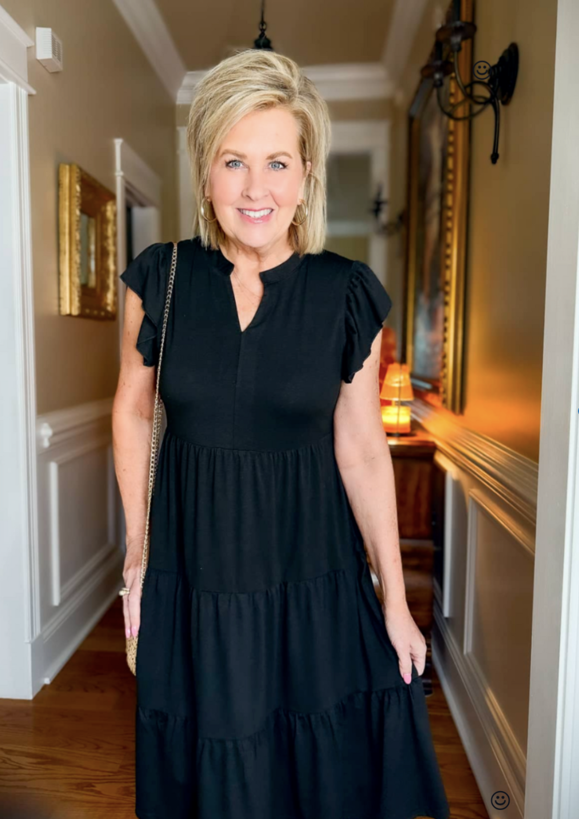 Tania Stephens, wearing a black midi dress that is appropriate for work, play, or even when attending a funeral.