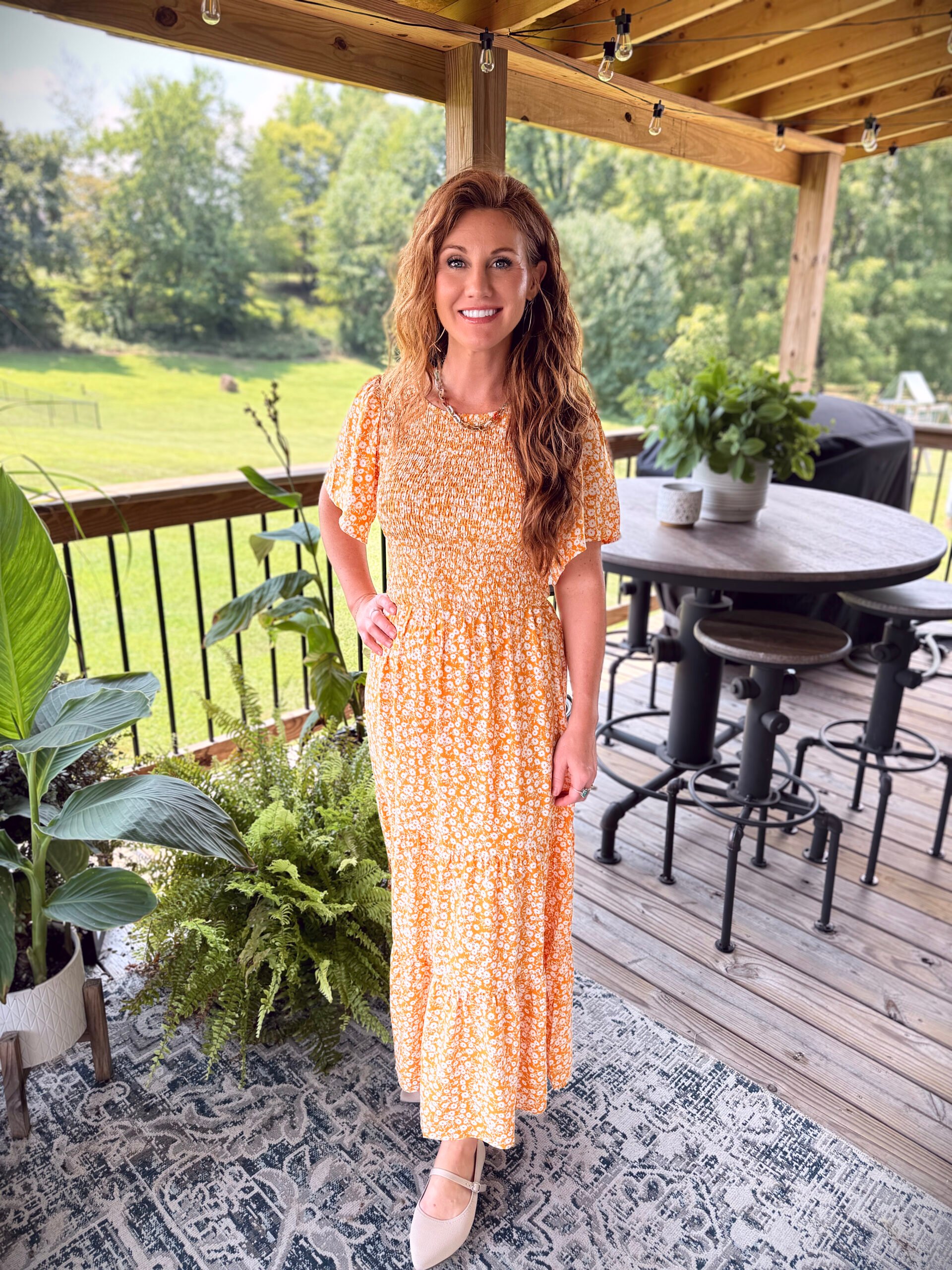Stephanie wearing a orange and white maxi dress
