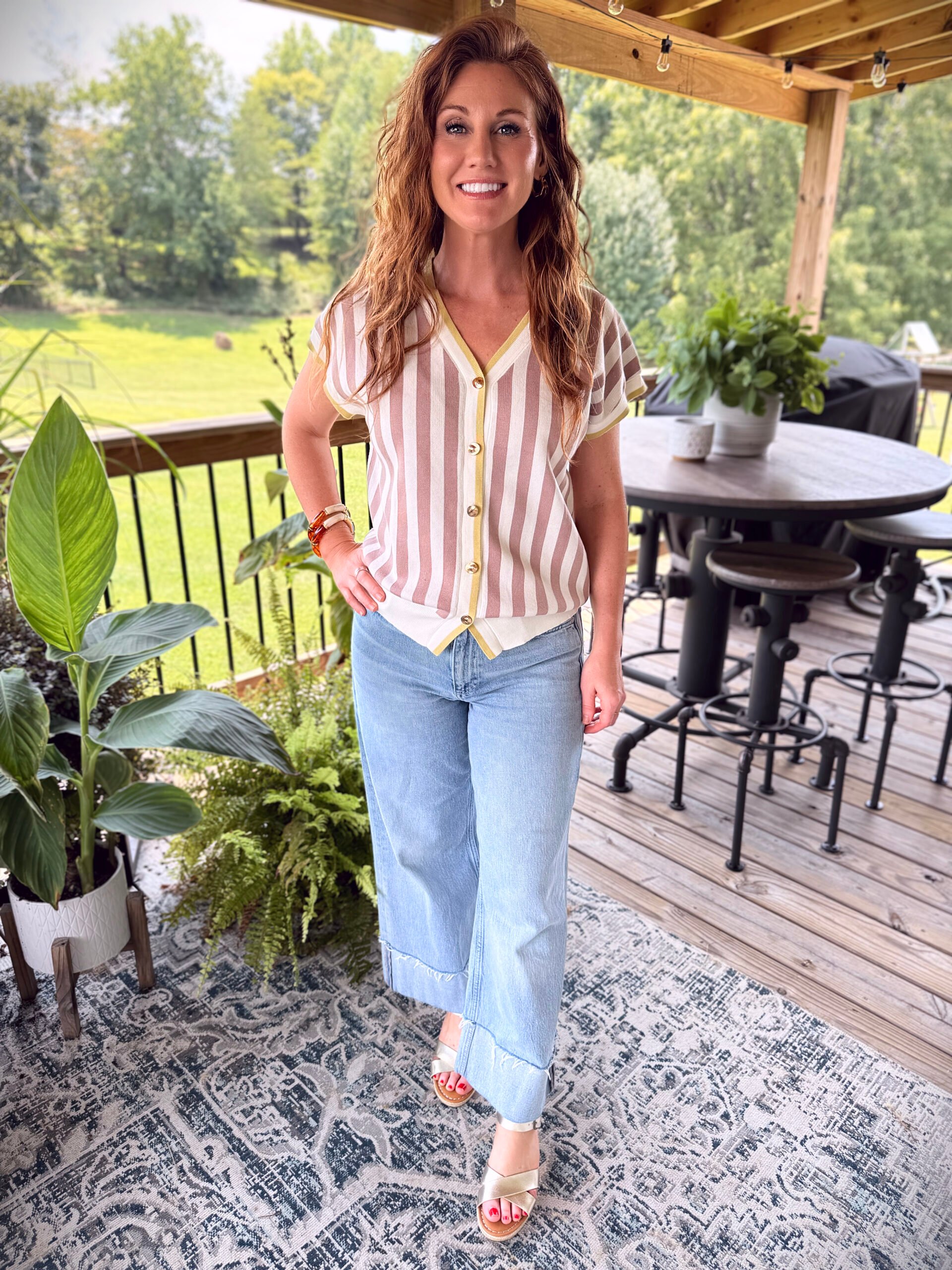 Stephanie wearing a striped vest from Amazon with lightwash jeans