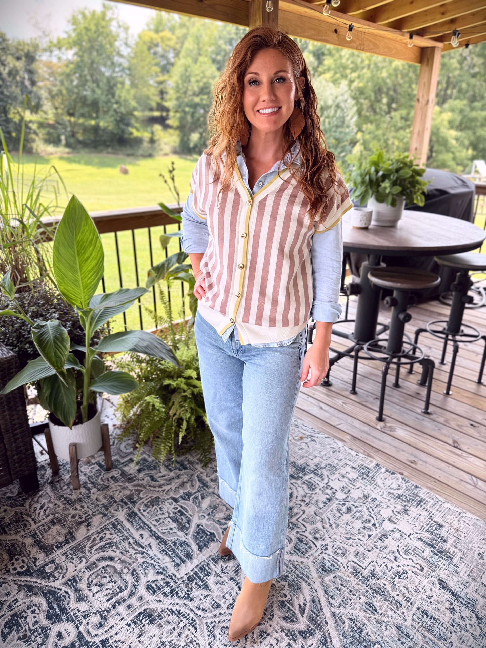 Stephanie wearing a striped vest from Amazon with a blue shirt and light wash jeans