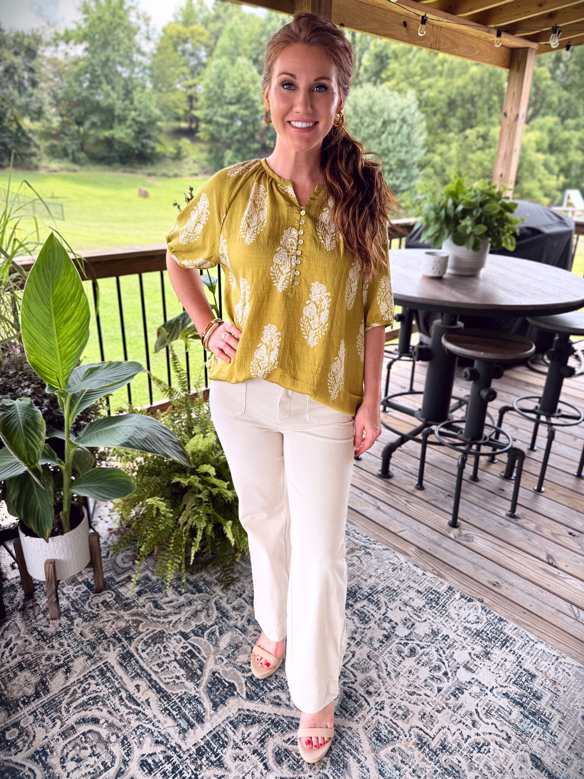 Stephanie wearing a chartreuse top from Amazon with light corduroy pants