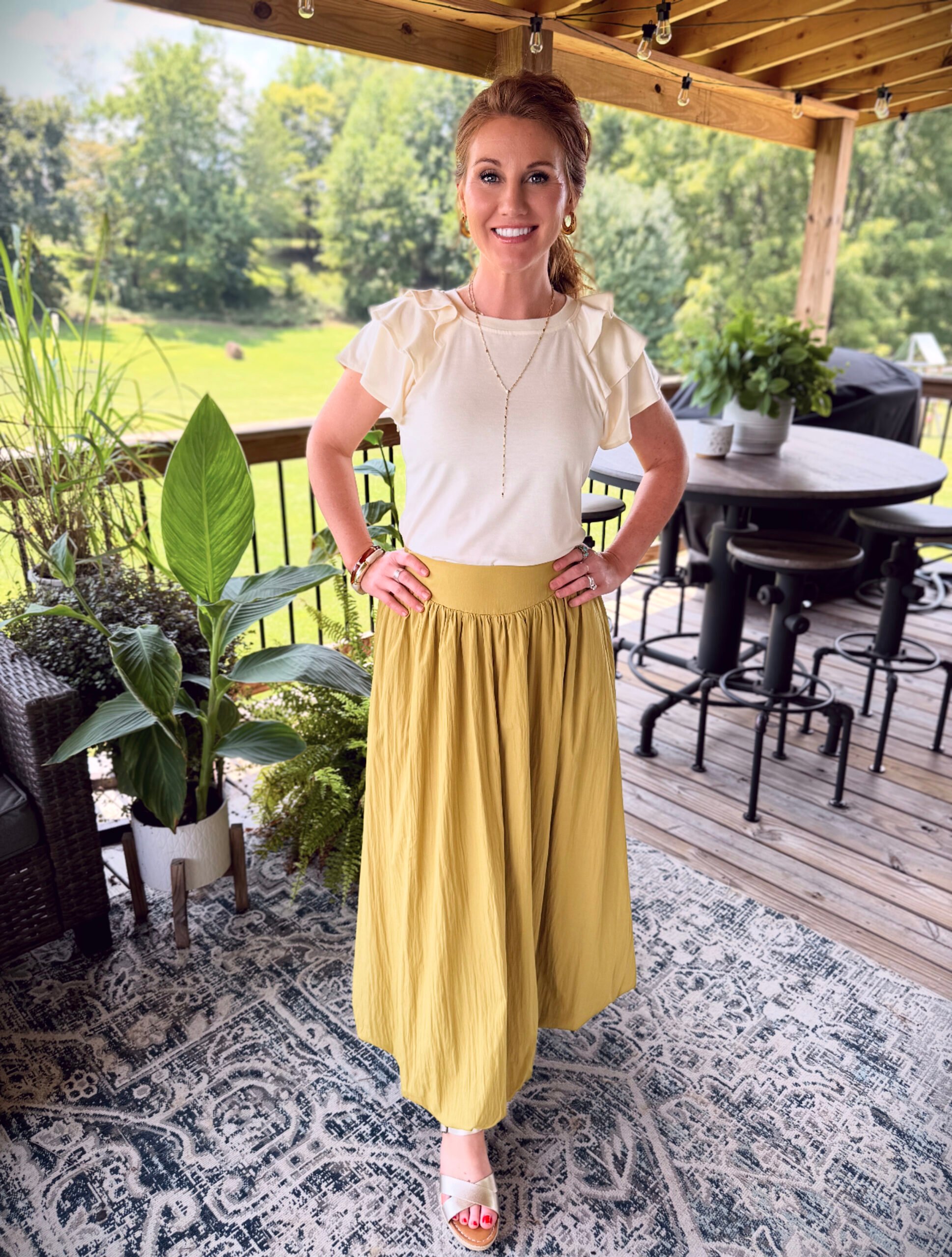 Stephanie wearing a chartreuse bubble skirt from Amazon with a light ruffle top