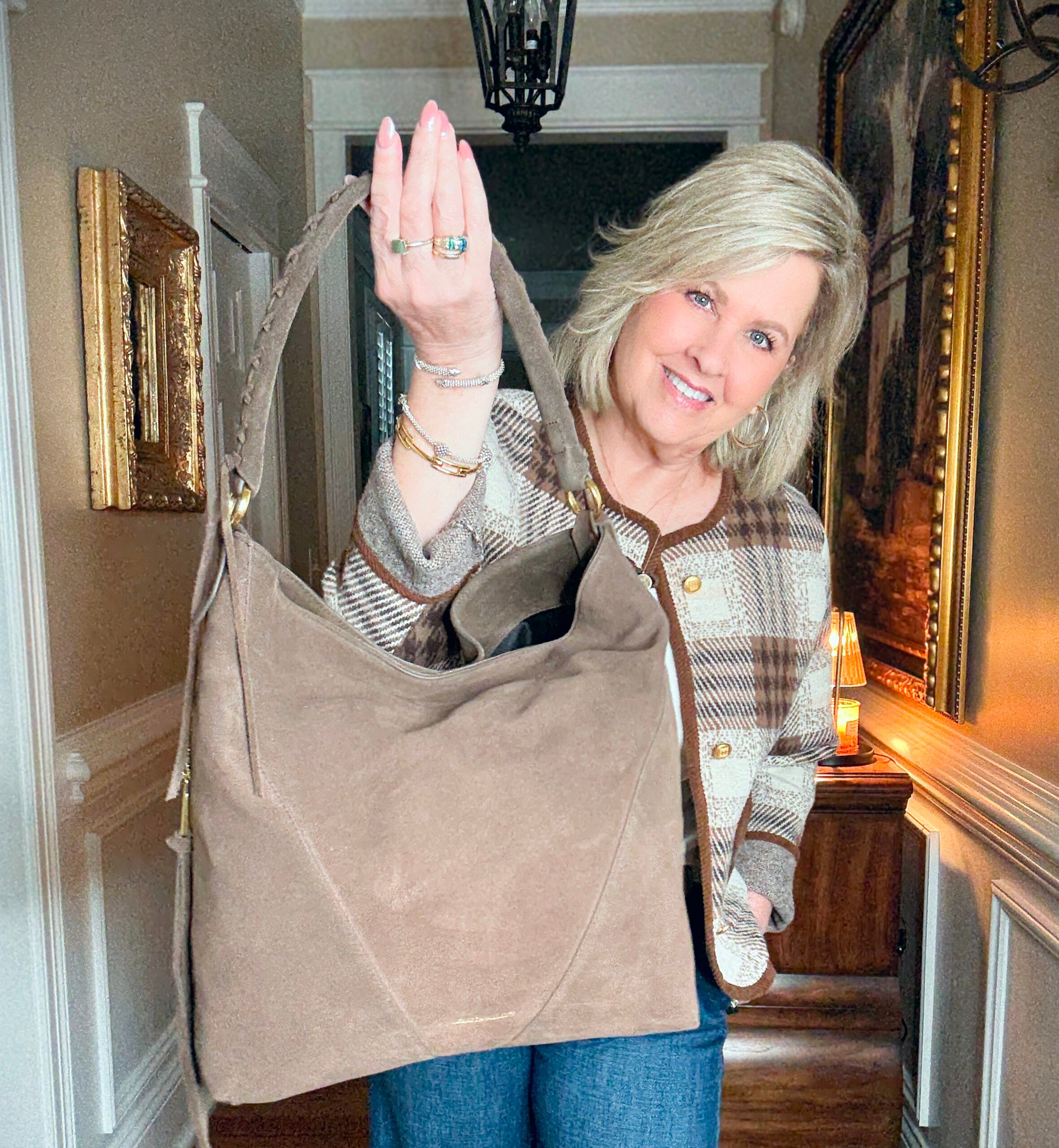 Tania is wearing an plaid jacket with a Rebecca handbag
