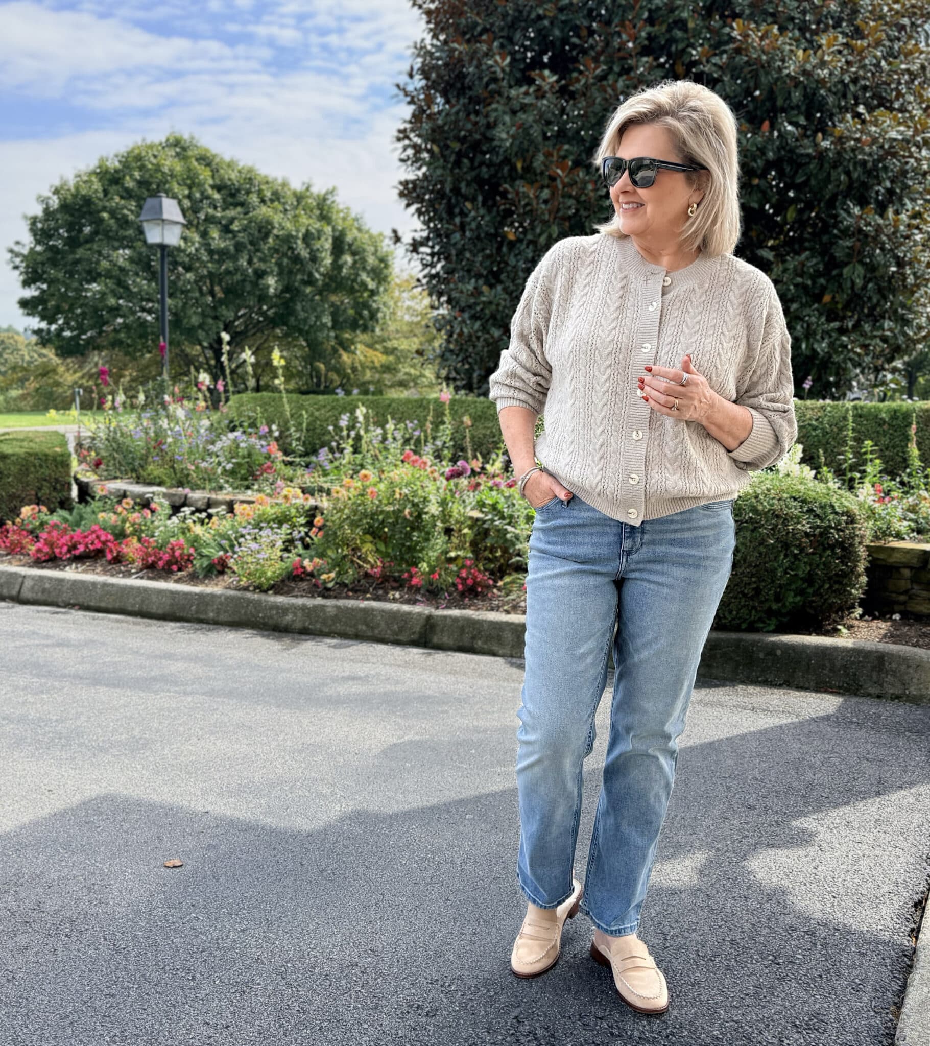 Tania wearing a taupe cable knit cardigan and straight leg jeans from Kohl's