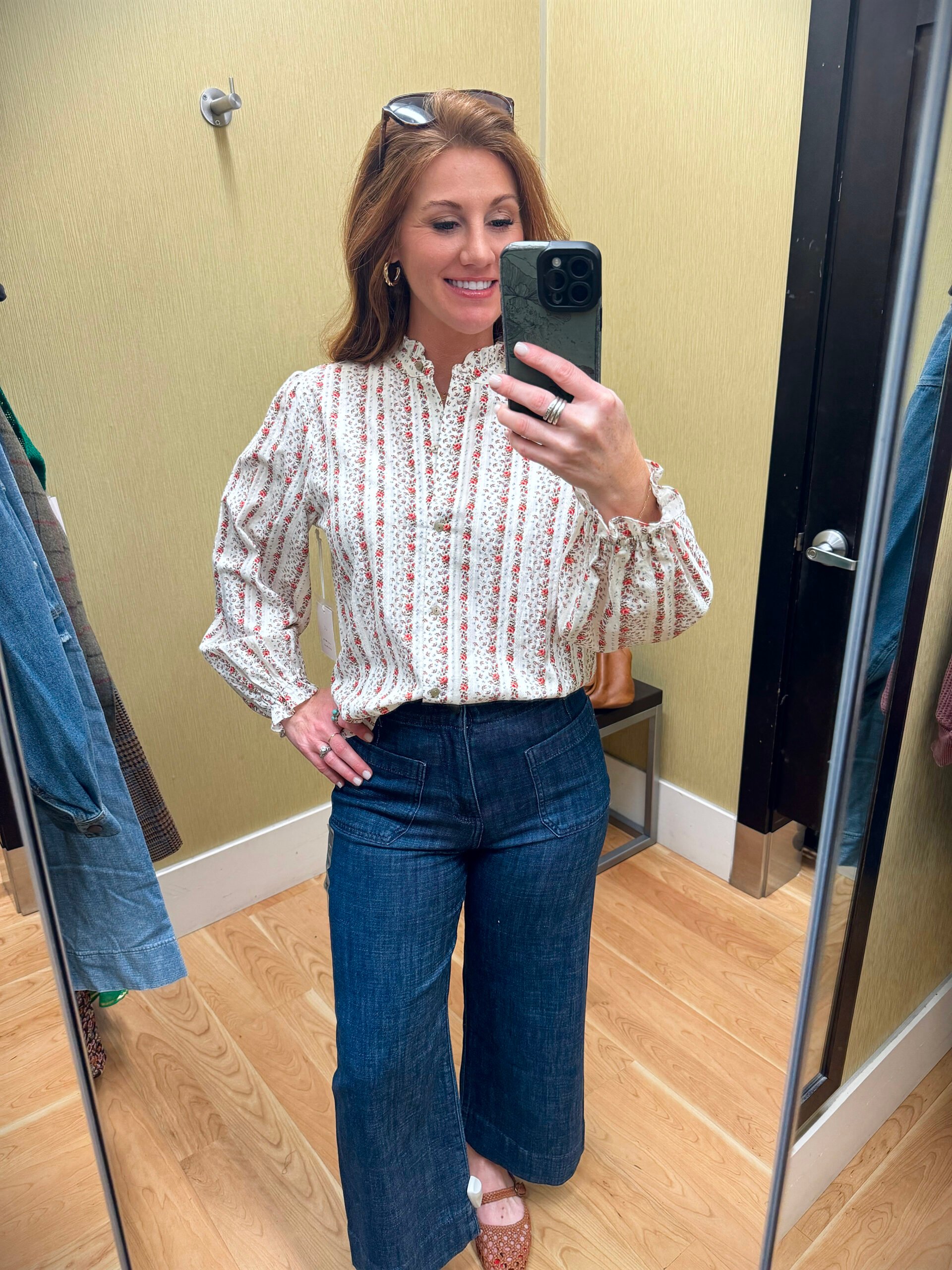 Stephanie wearing a ruffle collar blouse with button details from Kohl’s