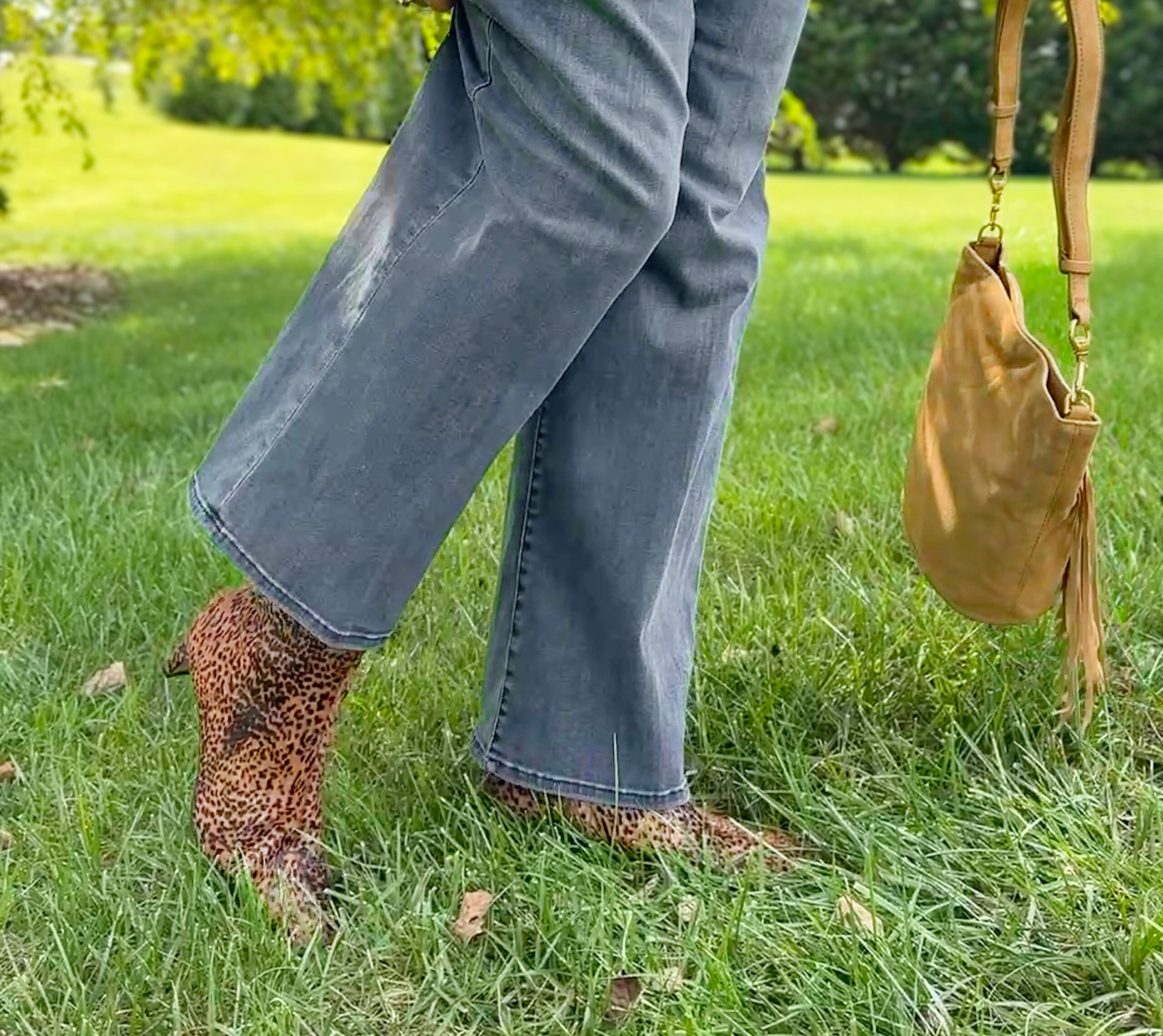 Pointed toe genuine calf hair booties adding western flair to a fall outfit for women over 50.