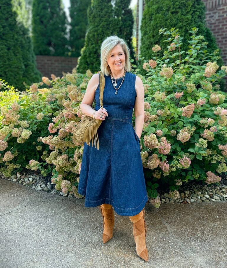 Tania Stephens wearing a fit and flare denim dress with patchwork boots and a crossbody; both with fringe