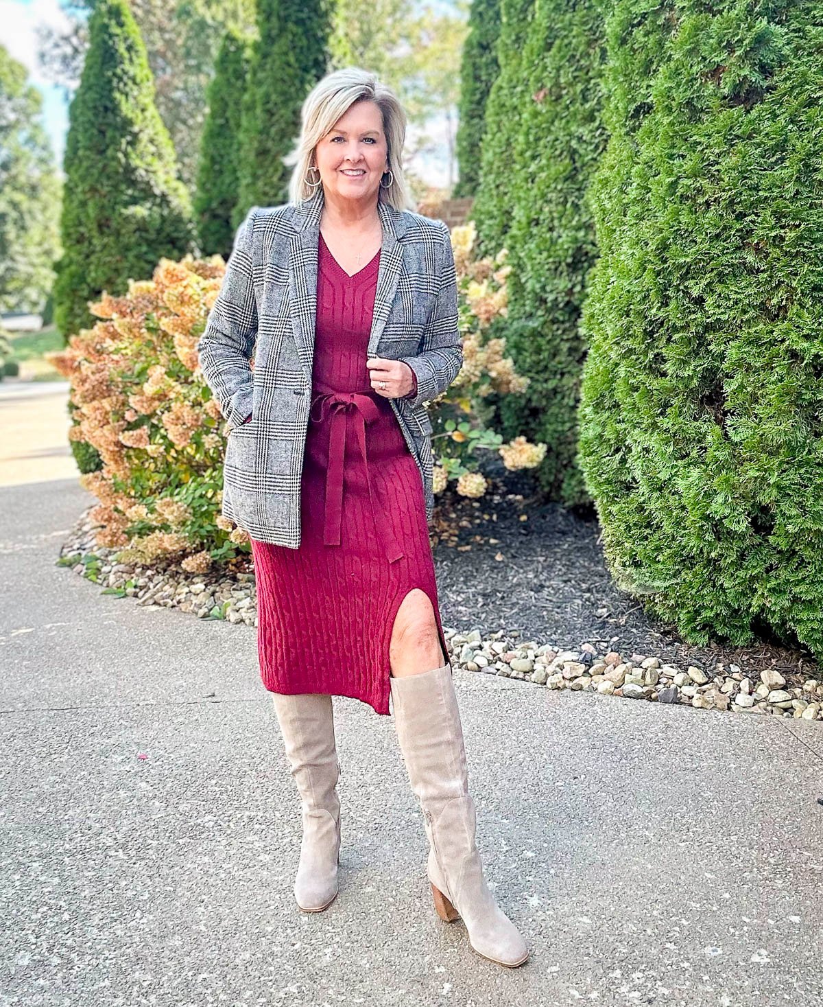 A woman showing how to style a dress with boots for fall and winter 2025