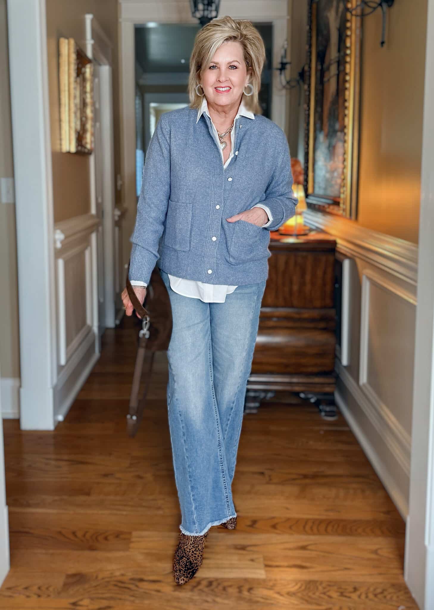 Tania is wearing an Amazon Blue Cardigan with a White Button Down Shirt and jeans