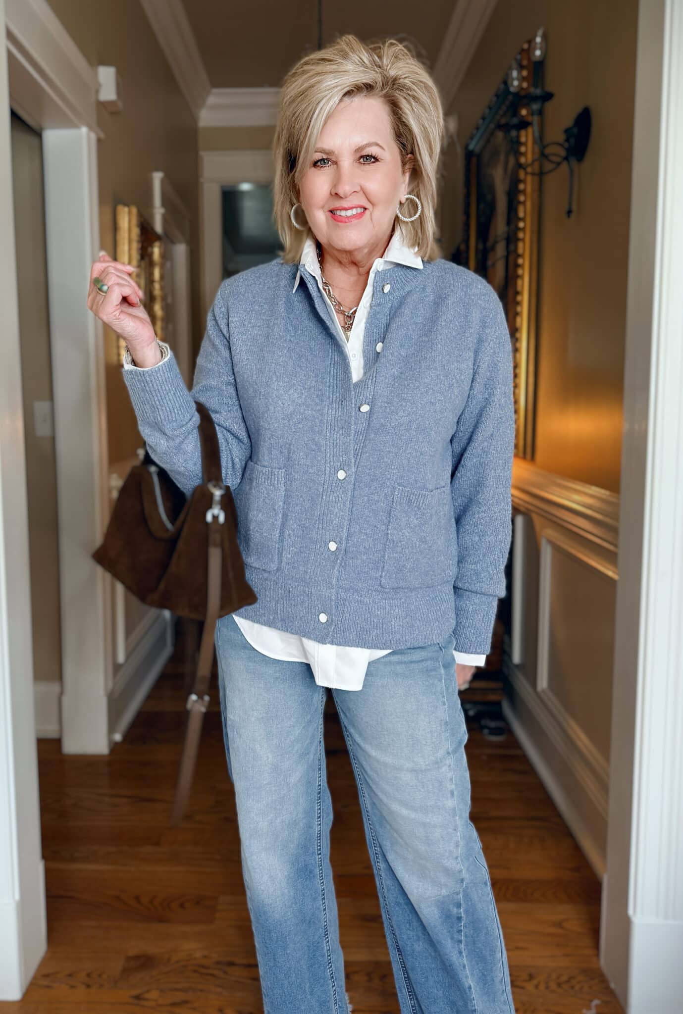 Tania is wearing an Amazon Blue Cardigan with a White Button Down Shirt with jeans