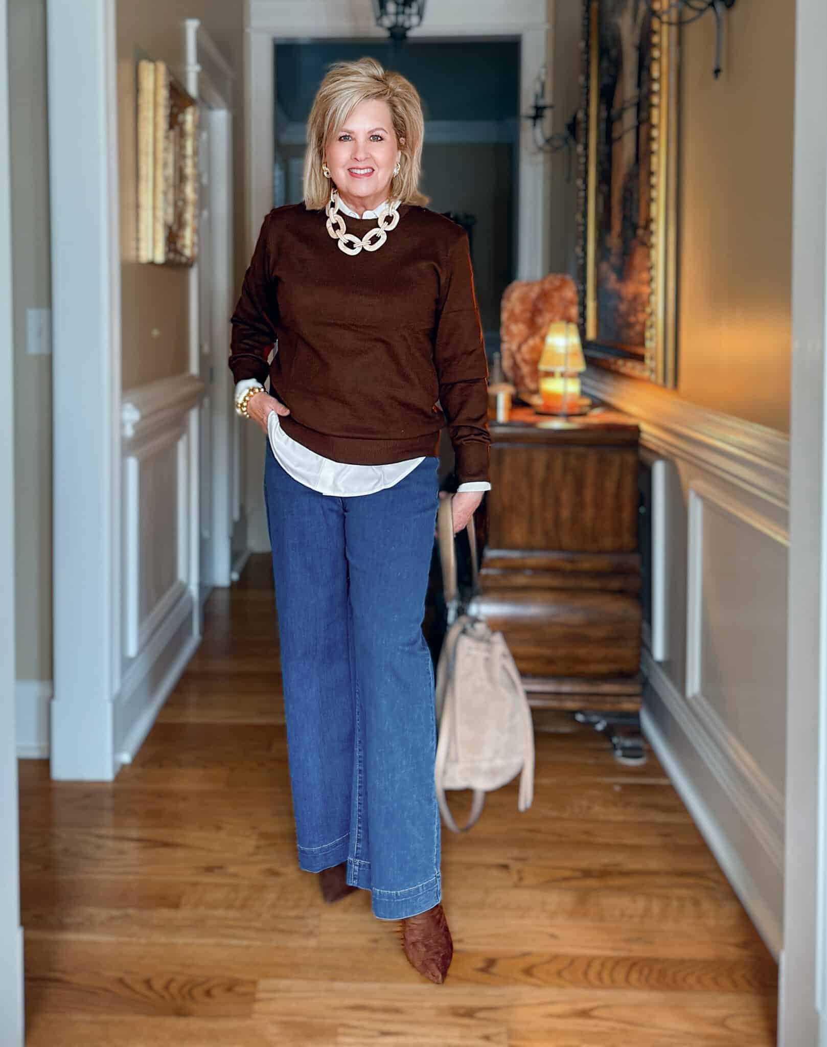 Tania is wearing an Amazon Brown Sweater with a White Button Down Shirt and jeans