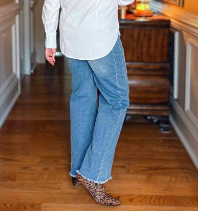 Tania wearing a pair of Amazon raw hem jeans and animal print boots by Splendid