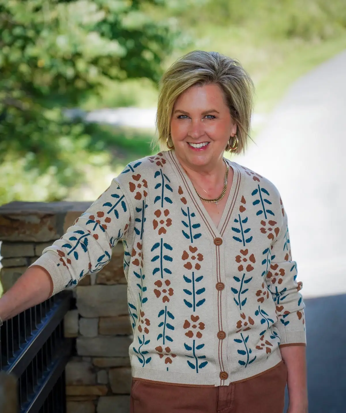 A floral print cardigan styled for fall on a woman over 50