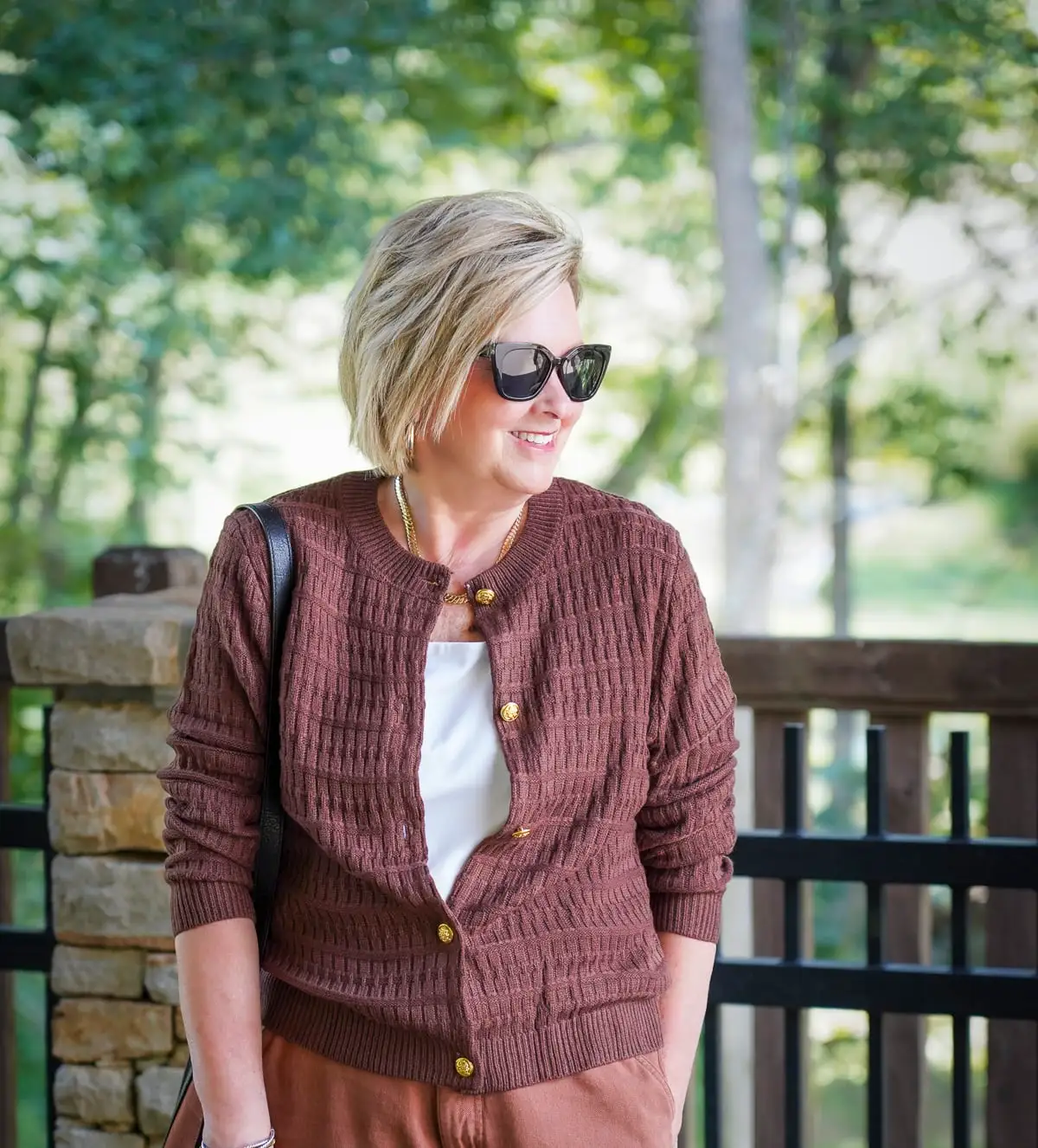 An affordable cute cardigan with gold buttons from Amazon on a woman