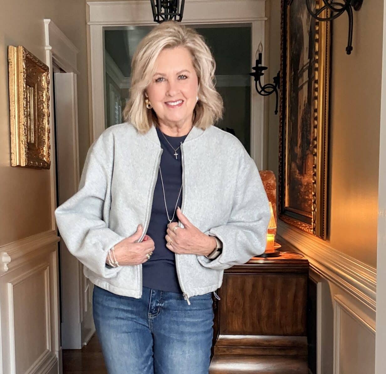 Tania wearing a navy tee with a light gray bomber jacket from Amazon