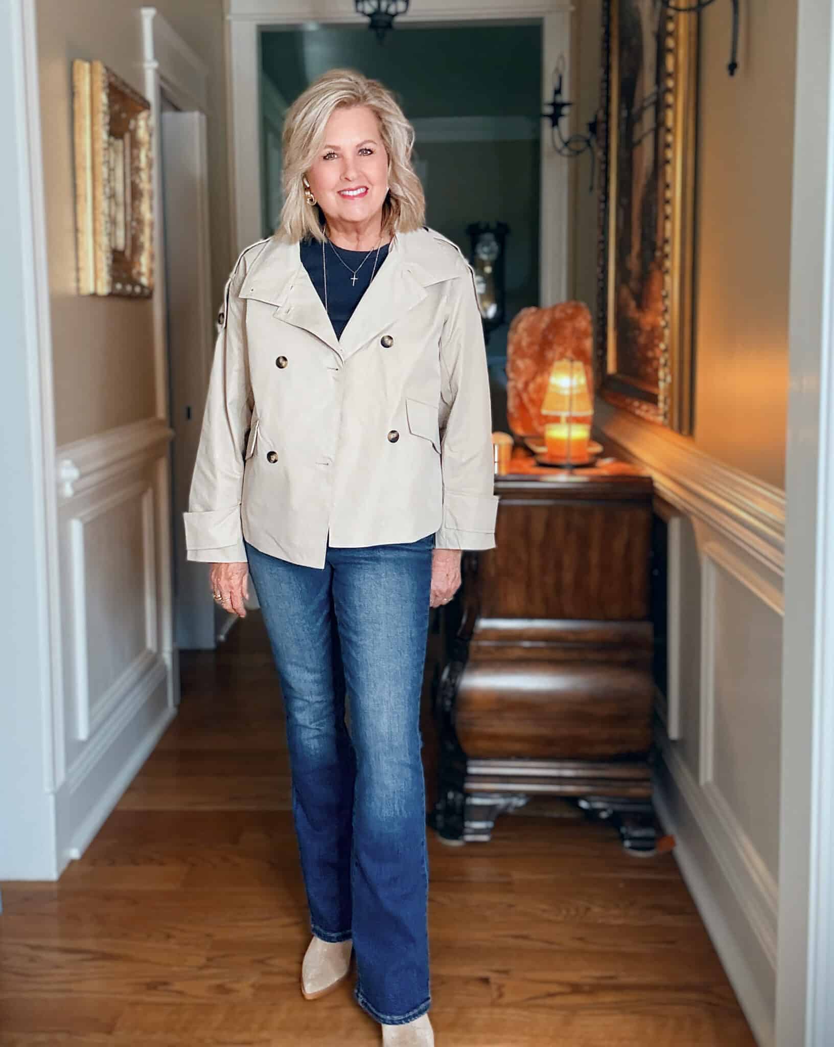 Tania wearing a navy tee and jeans with a light weight cropped trench jacket from Amazon