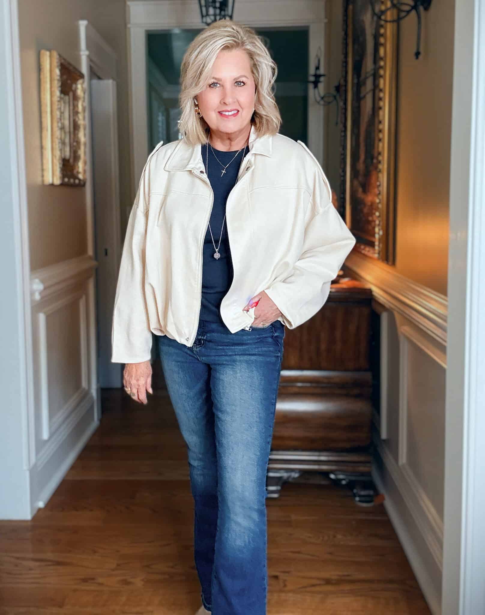 Tania wearing a navy tee and jeans with a light colored cropped cloud jacket from Amazon