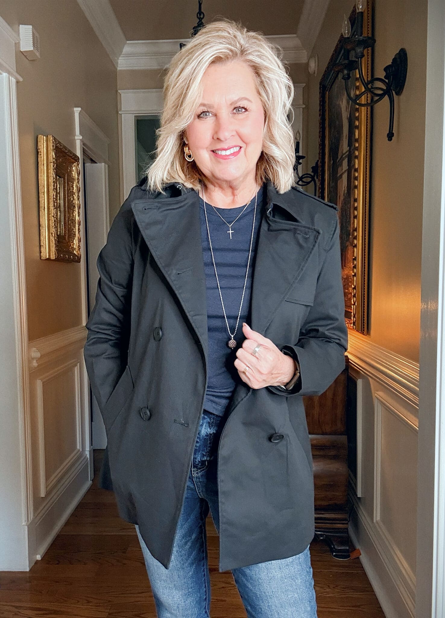 Tania wearing a navy tee with a black short trench jacket from Quince