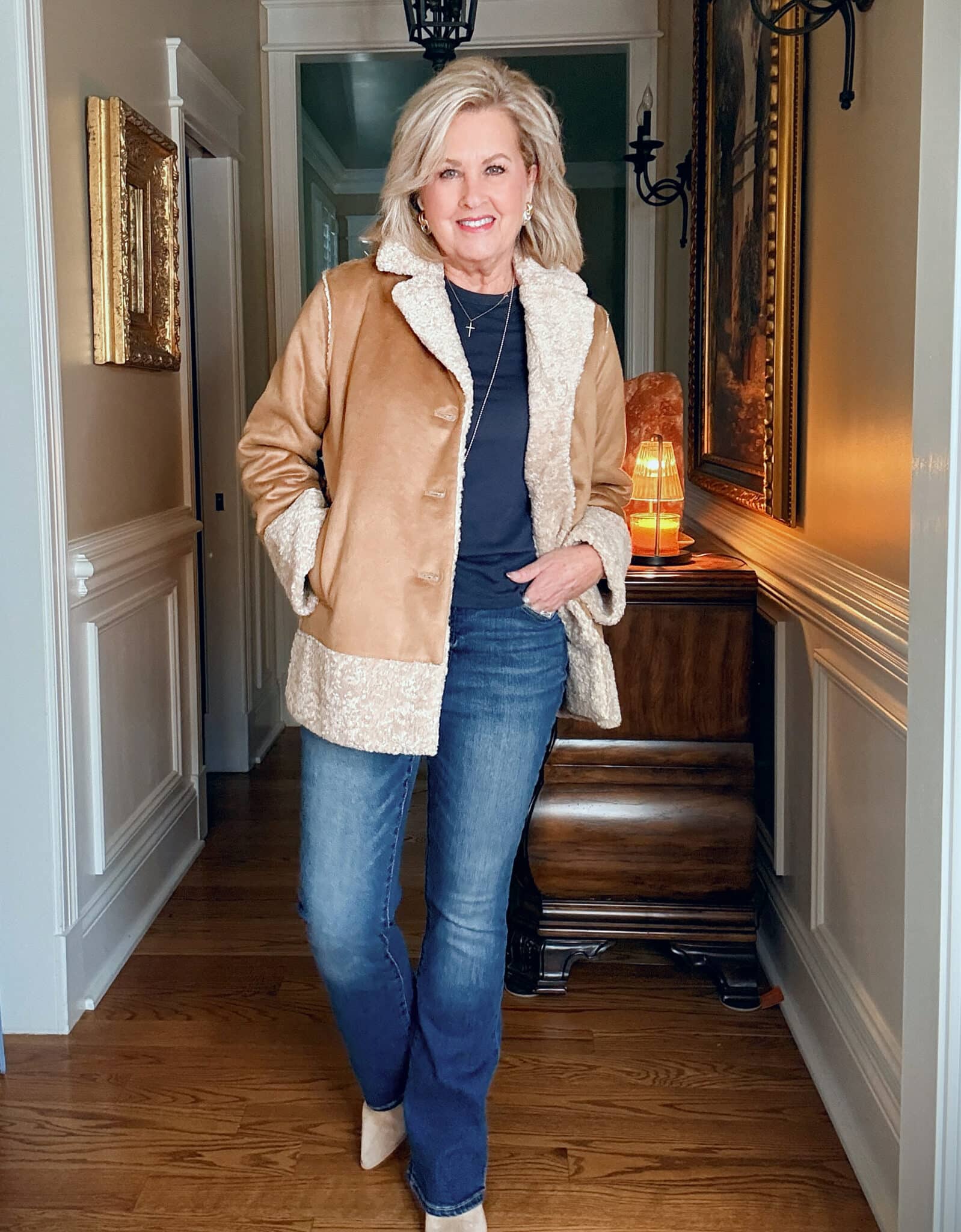 Tania wearing a navy tee and jeans with a camel  faux suede/shearling jacket from J.Jill