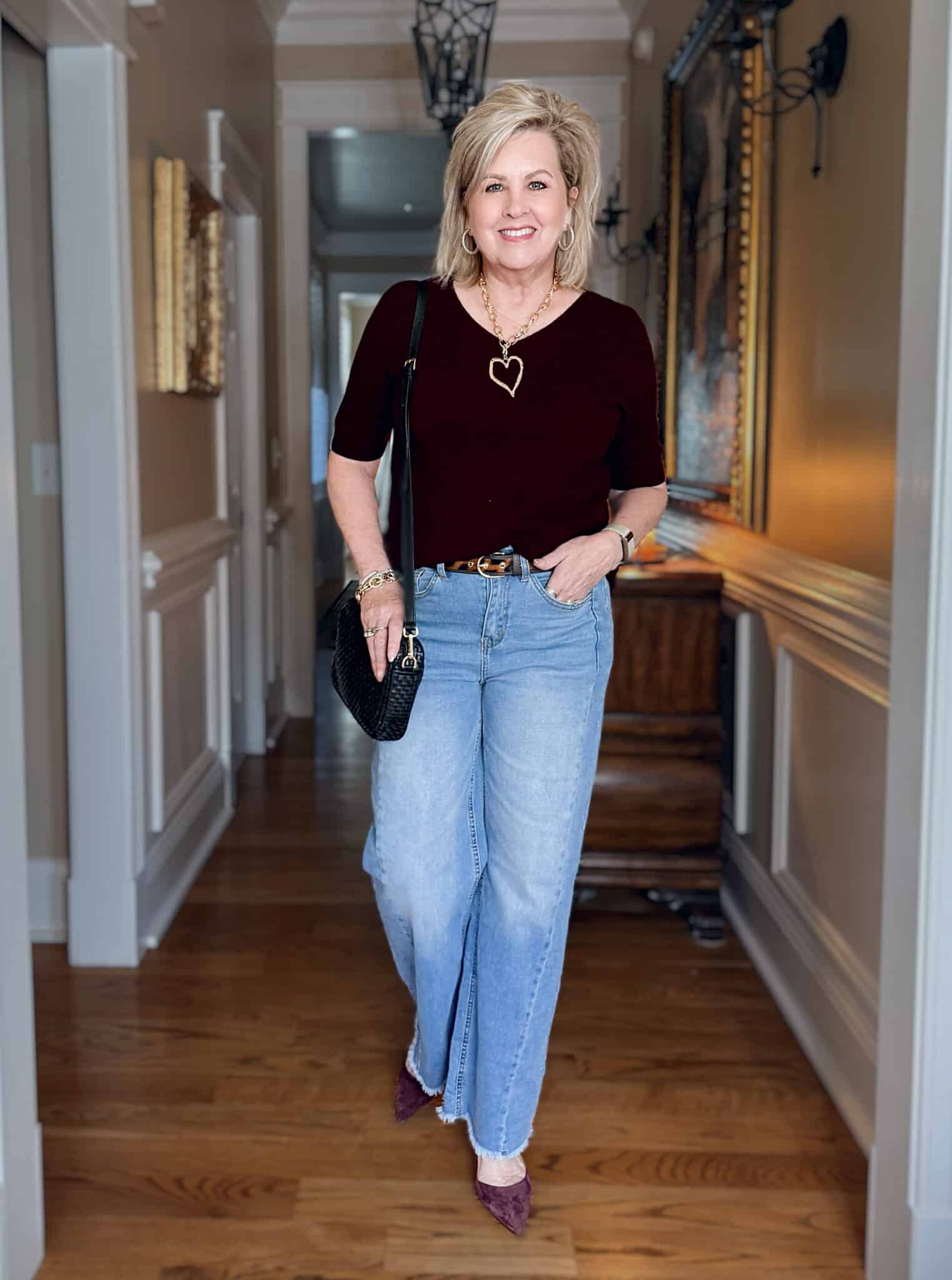 Tania wearing a burgundy sweater with light wash frayed jeans from Amazon