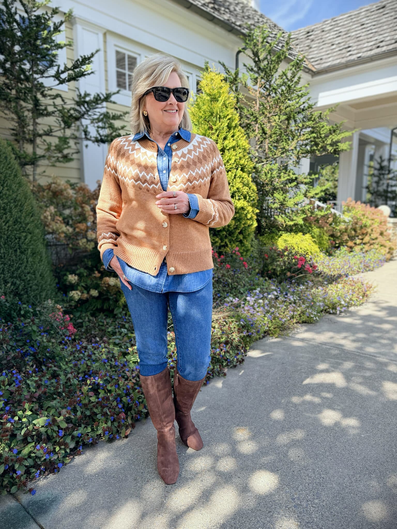 Tania Stephens wearing Talbots Fair Isle Cardigan layered over denim shirt with slim jeans and tall suede boots - cozy fall outfit for women over 50