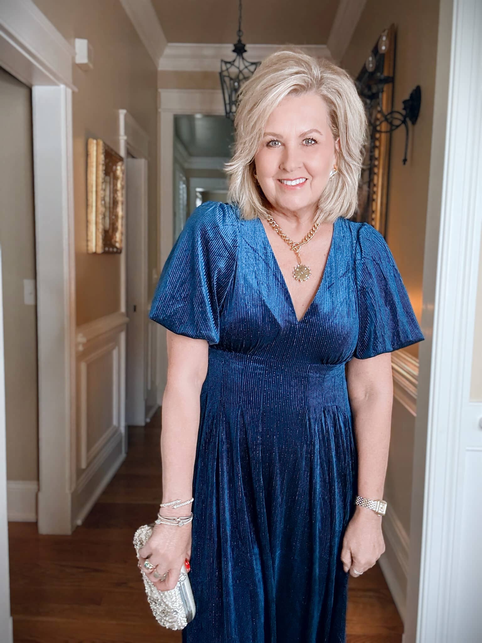 Tania wearing a V-Neck Amazon blue velvet dress with a metallic stripe