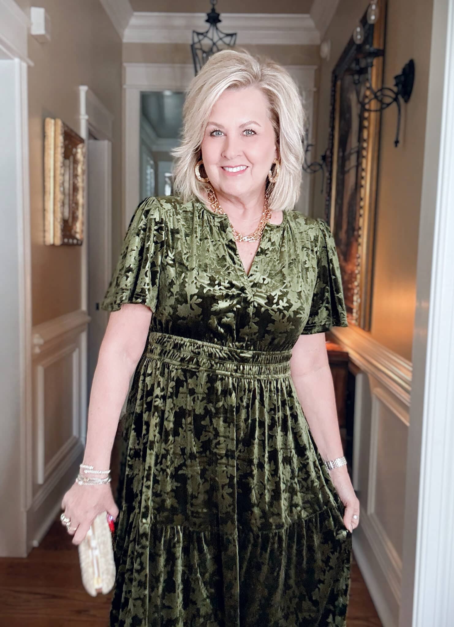 Tania wearing an Amazon green velvet dress with a gold necklace