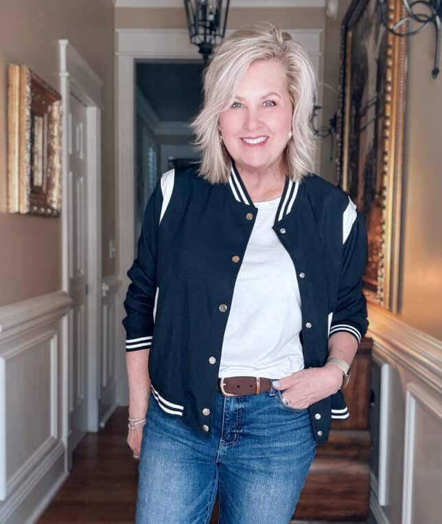 Tania wearing a navy bomber jacket with a white t-shirt
