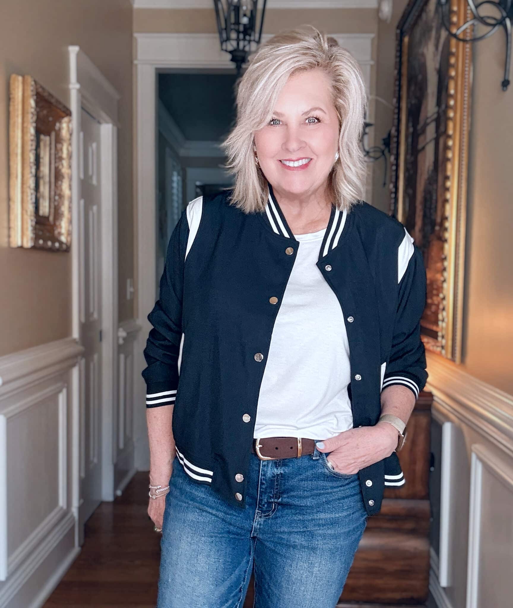 Tania wearing a navy bomber jacket with a white t-shirt