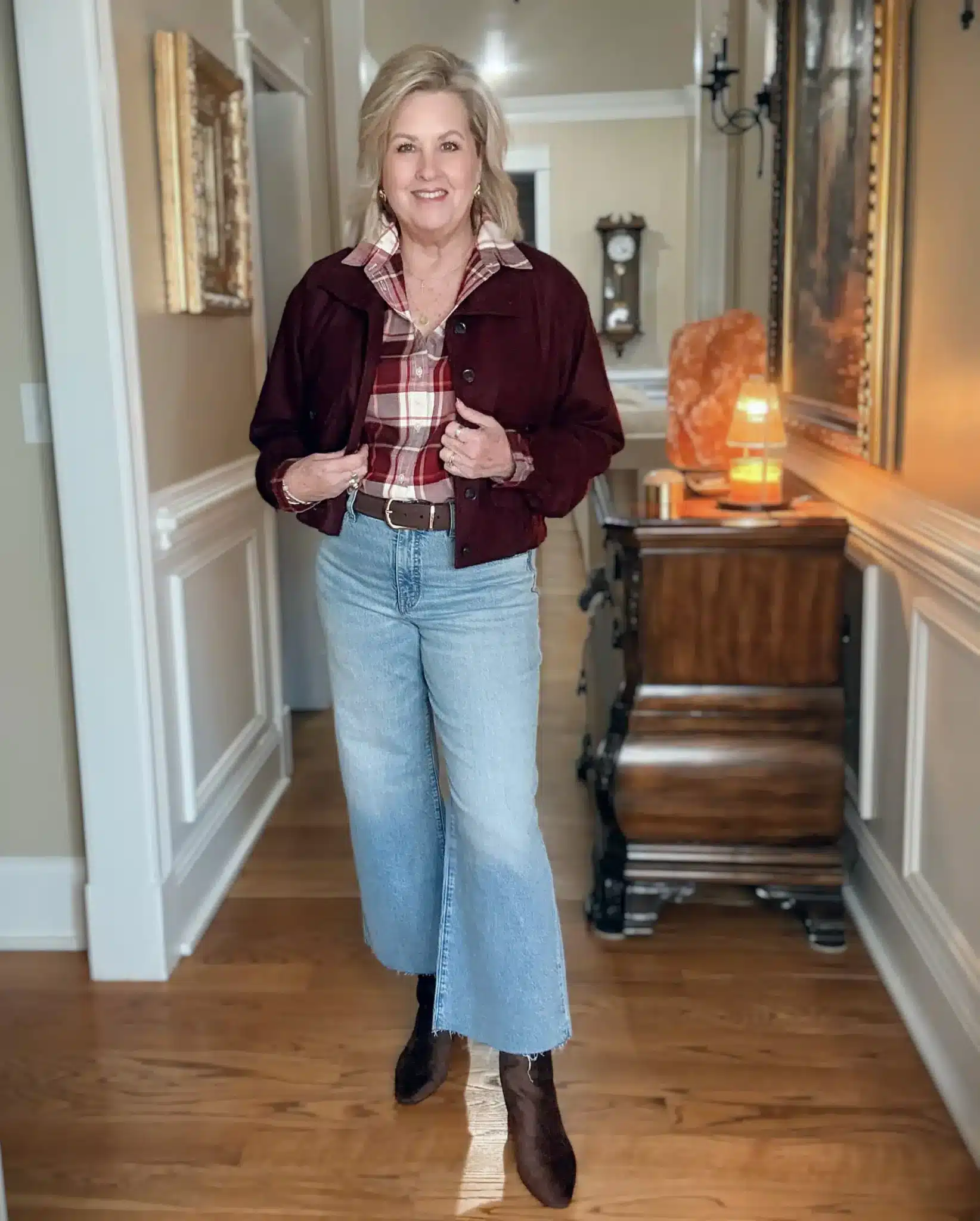Tania wearing a plaid shirt with jacket, jeans, and boots for fall.