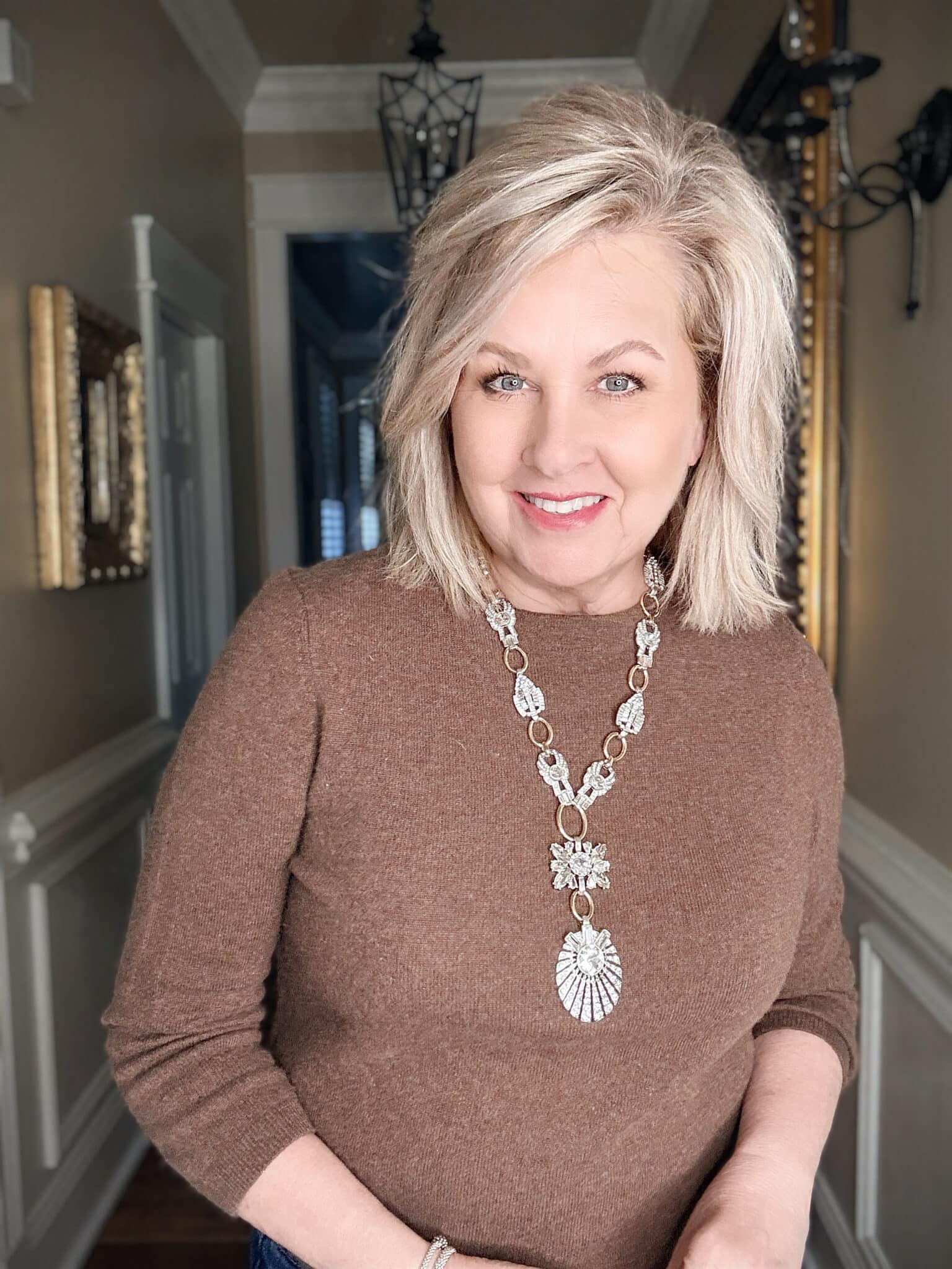 Chico’s Art Deco crystal Y-necklace styled over dark brown sweater