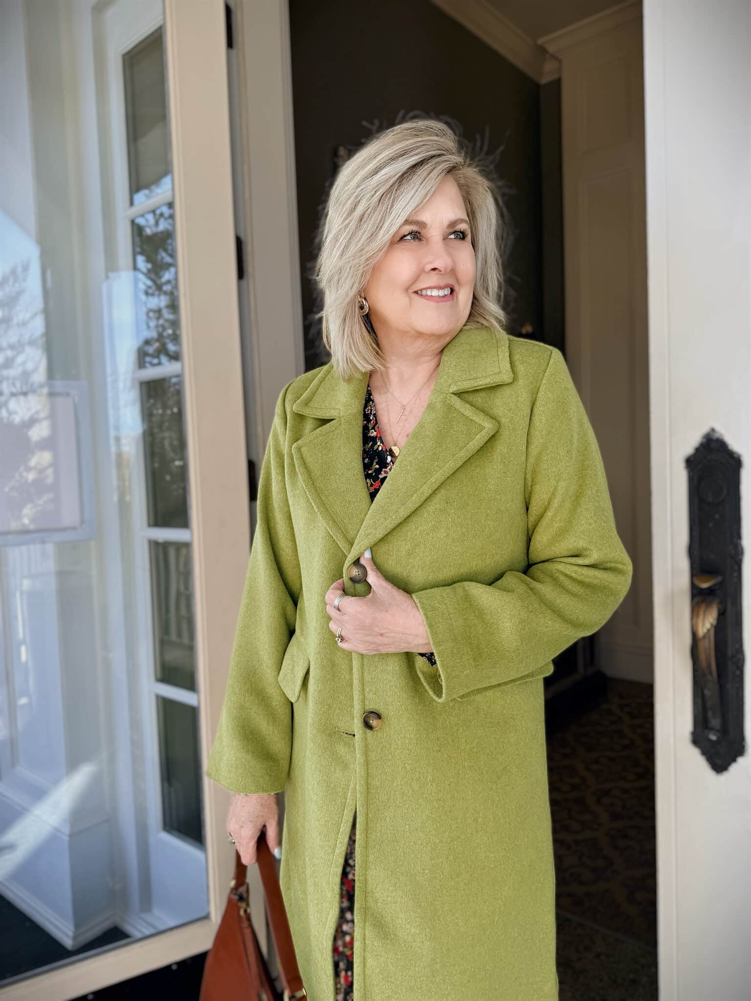 Tania wearing a green long coat from Kohl's