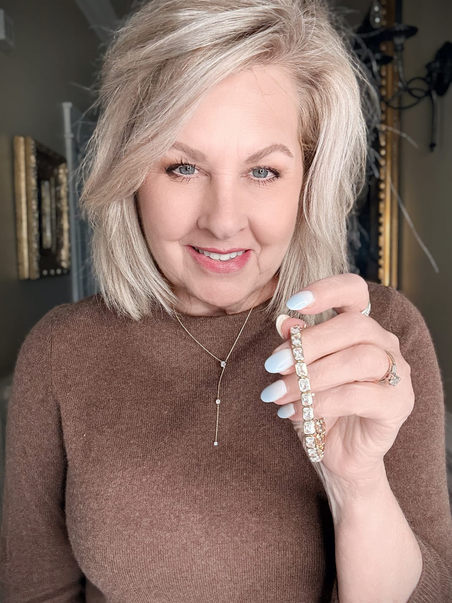 close-up of Electric Picks Jade Lariat Necklace and Prescott Bracelet adding sparkle to a holiday outfit