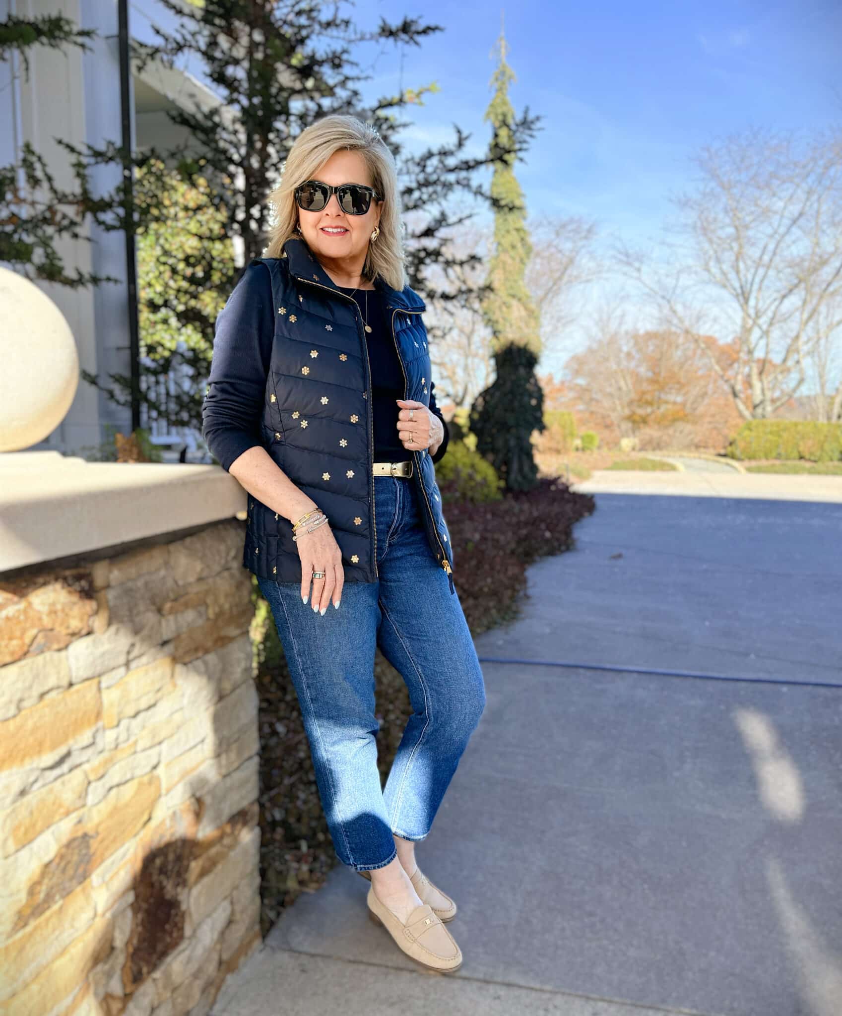 Talbots navy vest with gold snowflakes, slim jeans, and a navy tee