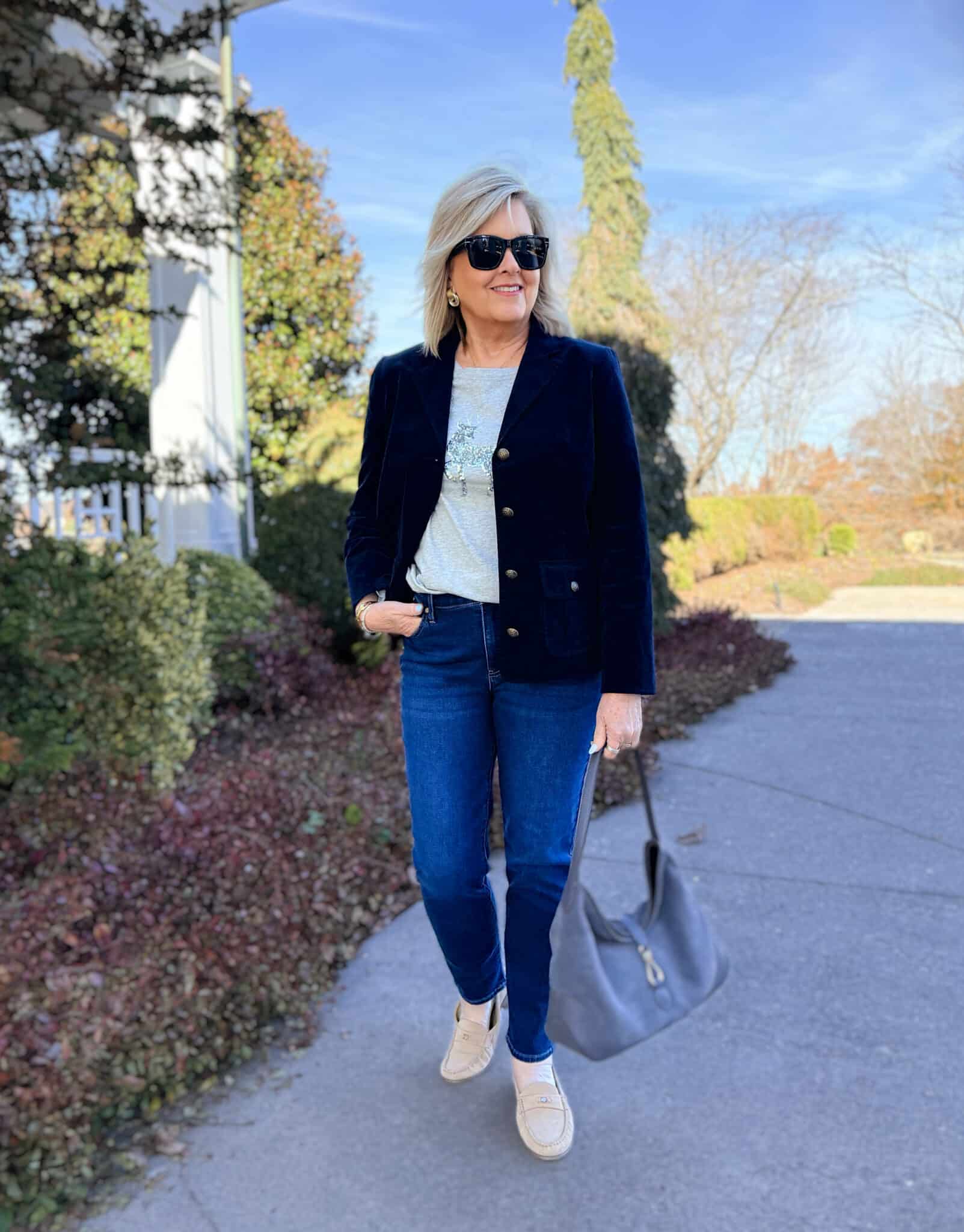 Tania is a navy velveteen blazer, deer sequin tee, and slim jeans from Talbots
