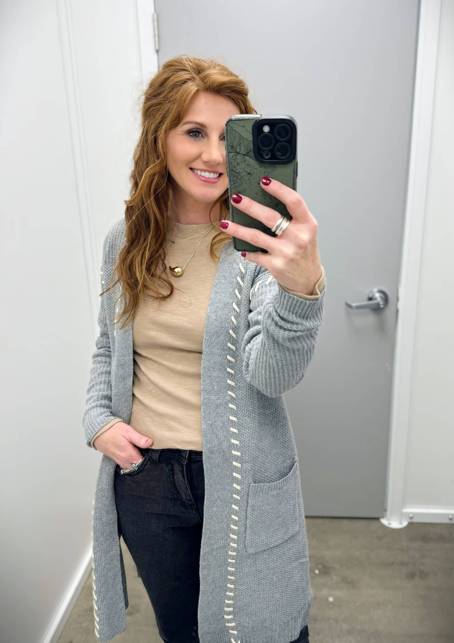 Stephanie wearing black jeans and a camel top with a long gray cardigan from Walmart