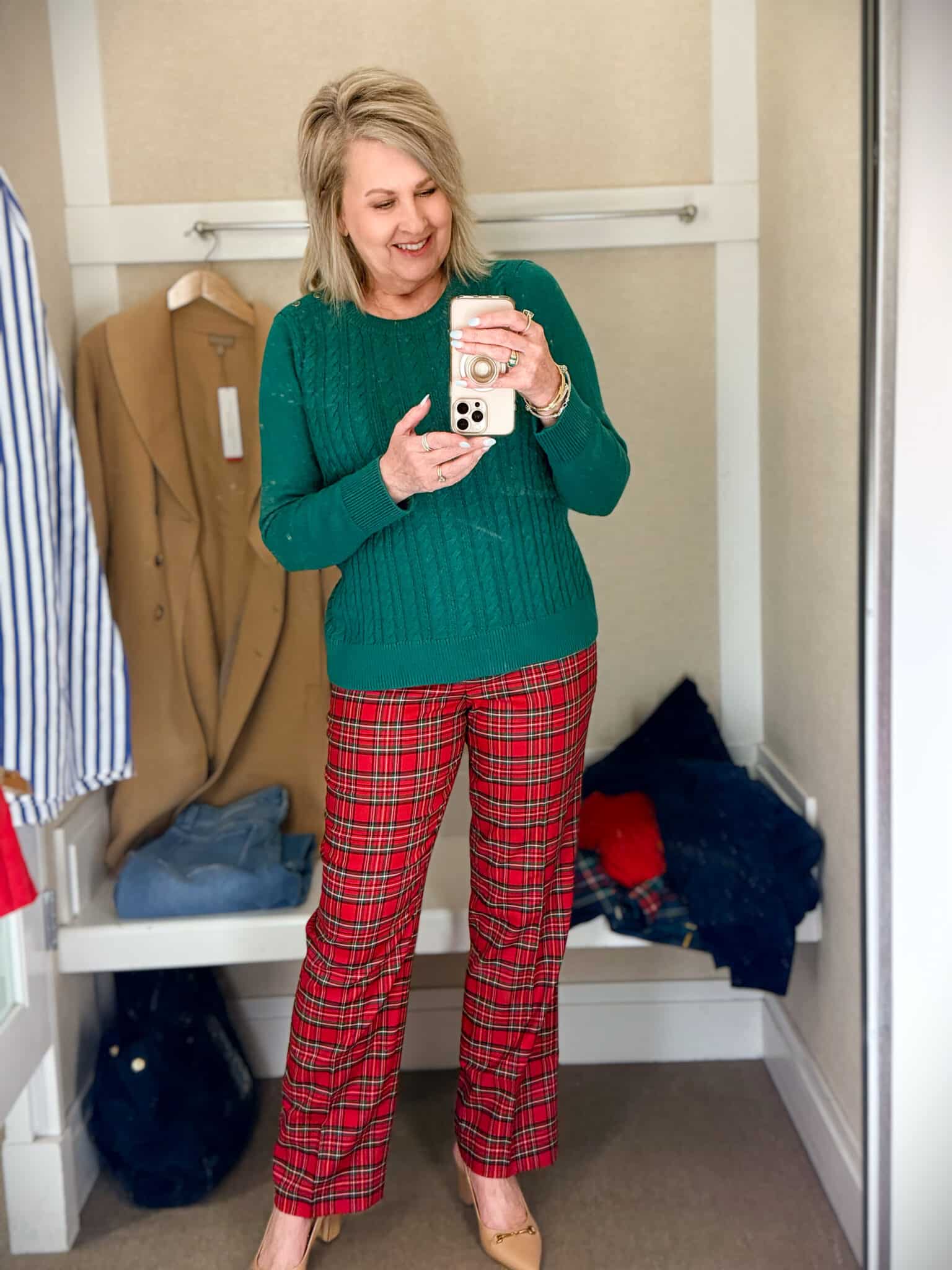 Tania trying on a green sweater with red plaid pants from Talbots