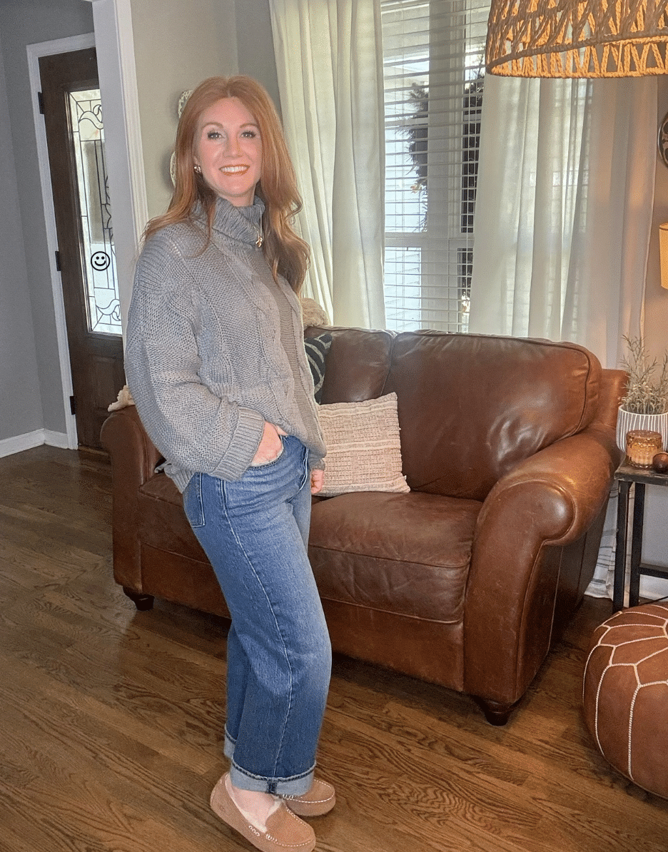 Cozy cable-knit turtleneck sweater and Levi’s ankle jeans styled on petite woman