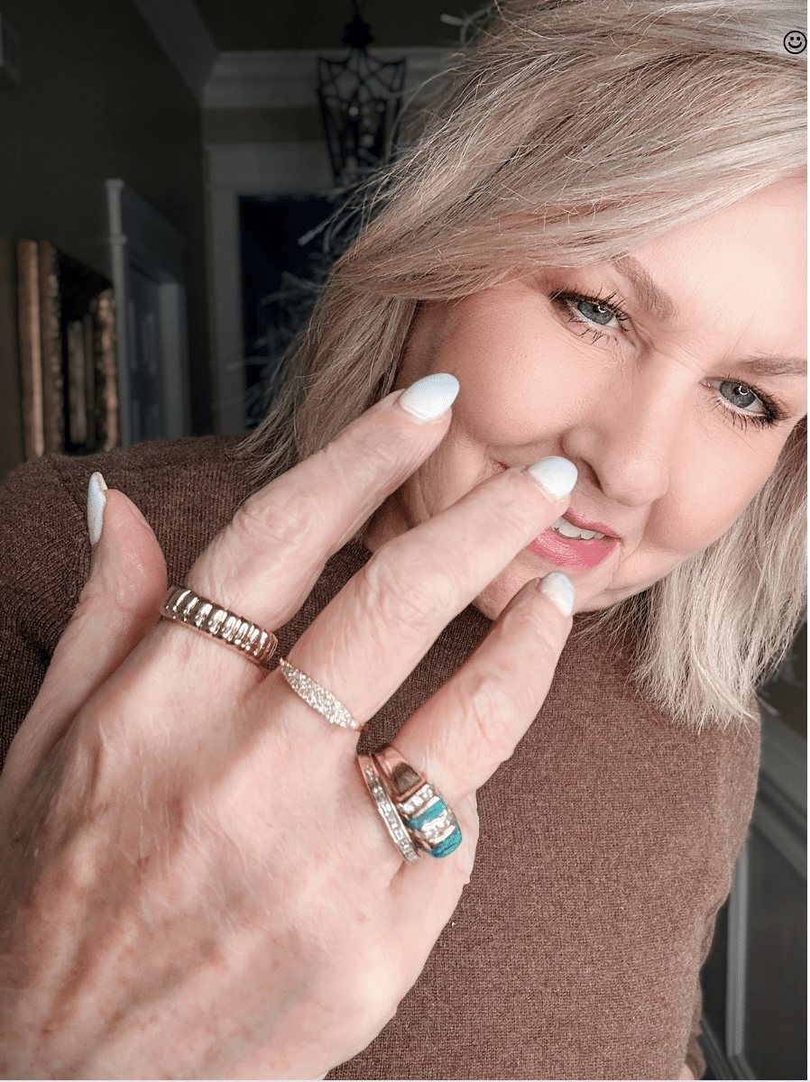 Mejuri minimalist gold ring stack on woman’s hand