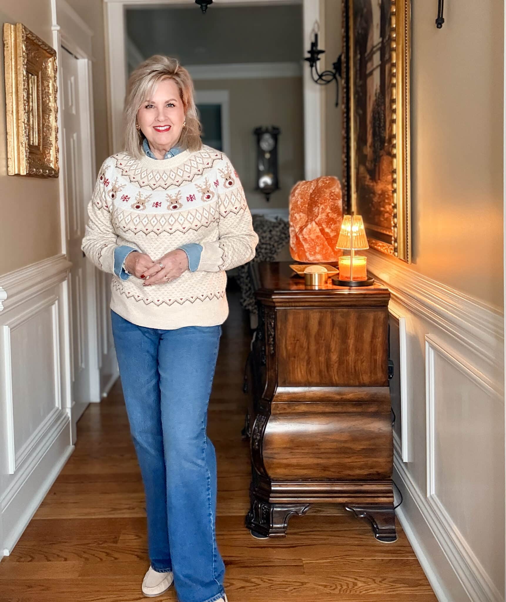 Tania wearing a reindeer holiday sweater and medium wash jeans from Walmart