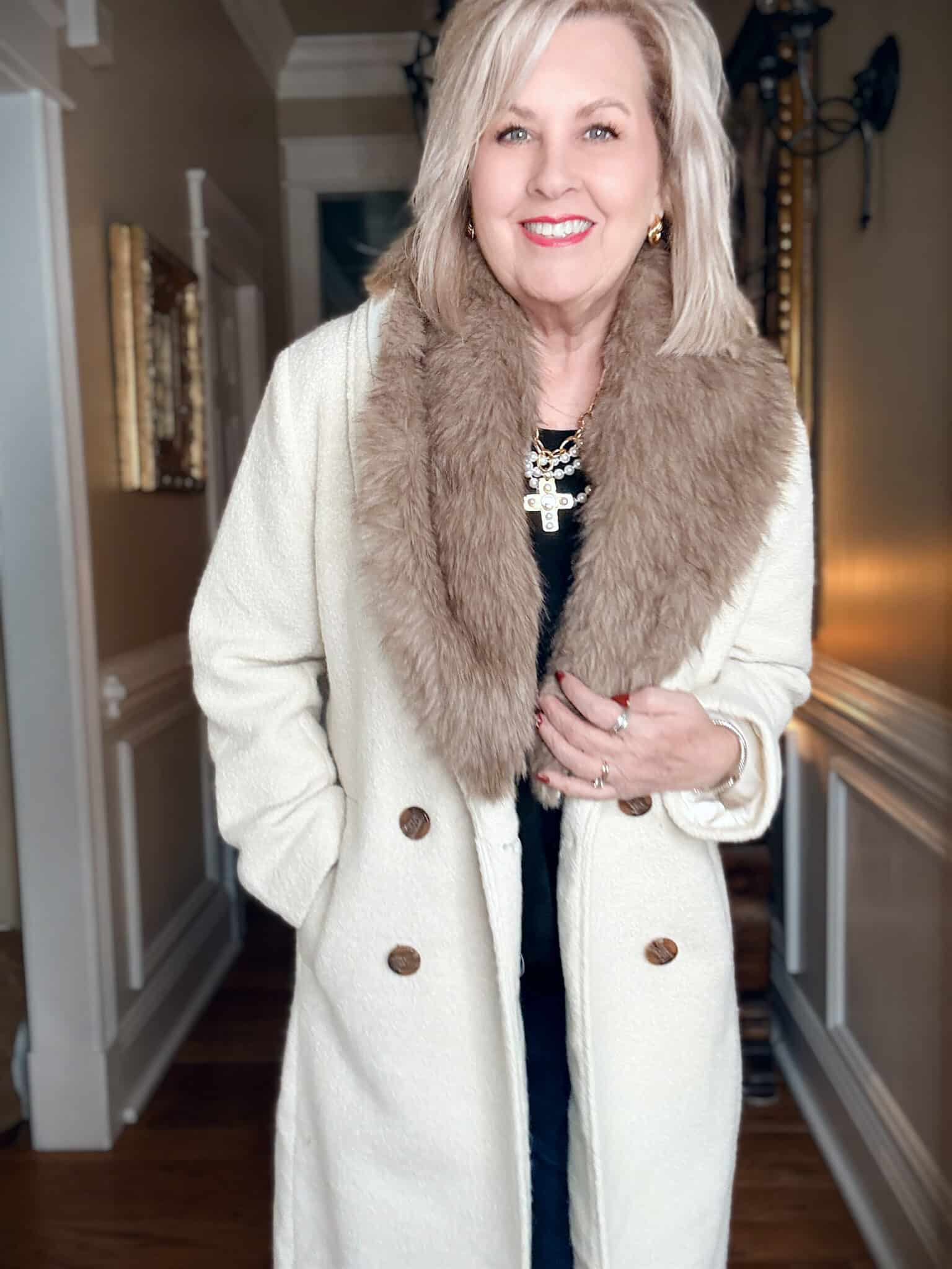 Tania wearing a double breasted winter white dress coat with a fur collar from Loft