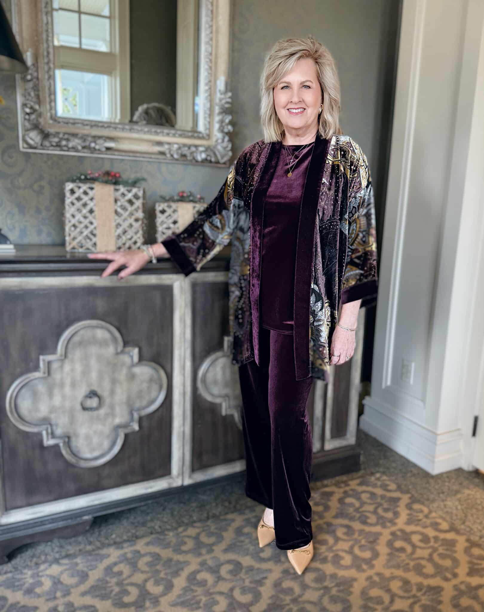 Tania in a Travelers Night Bloom velvet top and pants with a travelers cardigan