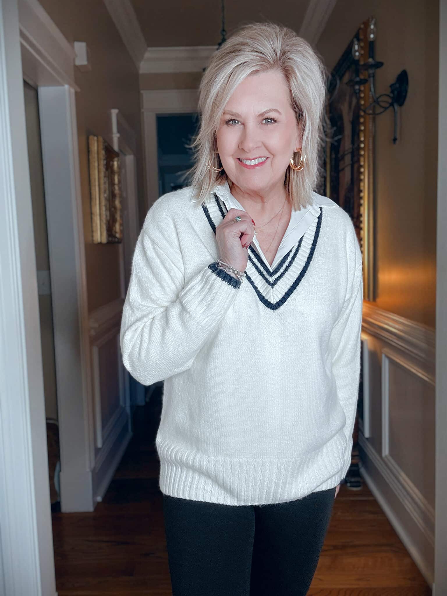 Tania wearing a varsity style sweater with a white button down shirt from Kohl's